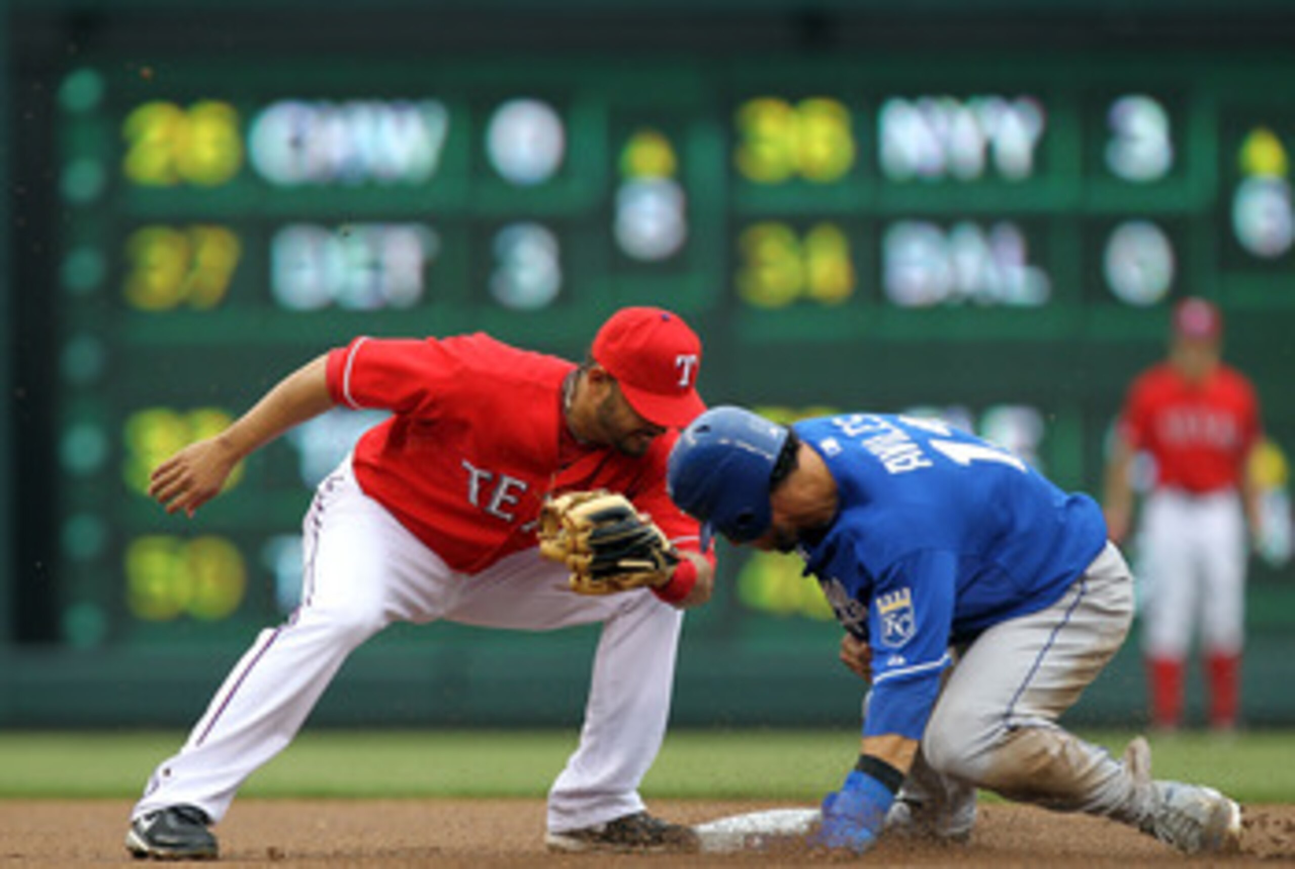 ARLINGTON, TX - APRIL 24: Mike Aviles #13 of the Kansas City Royals steals second base against Andres Blanco #3 of the Texas Rangers in the first inning at Rangers Ballpark in Arlington on April 24, 2011 in Arlington, Texas. (Photo by Ronald Martinez/Ge ARLINGTON, TX - APRIL 24: Mike Aviles #13 of the Kansas City Royals steals second base against Andres Blanco #3 of the Texas Rangers in the first inning at Rangers Ballpark in Arlington on April 24, 2011 in Arlington, Texas. (Photo by Ronald Martinez/Ge