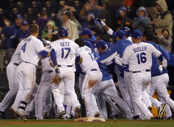 KANSAS CITY, MO - APRIL 21:  Melky Cabrera #53 of the Kansas City Royals is swarmed by teammates after knocking in the game-winning run to defeat the Cleveland Indians as the Royals win the game 3-2 on April 21, 2011 at Kauffman Stadium in Kansas City, Mi