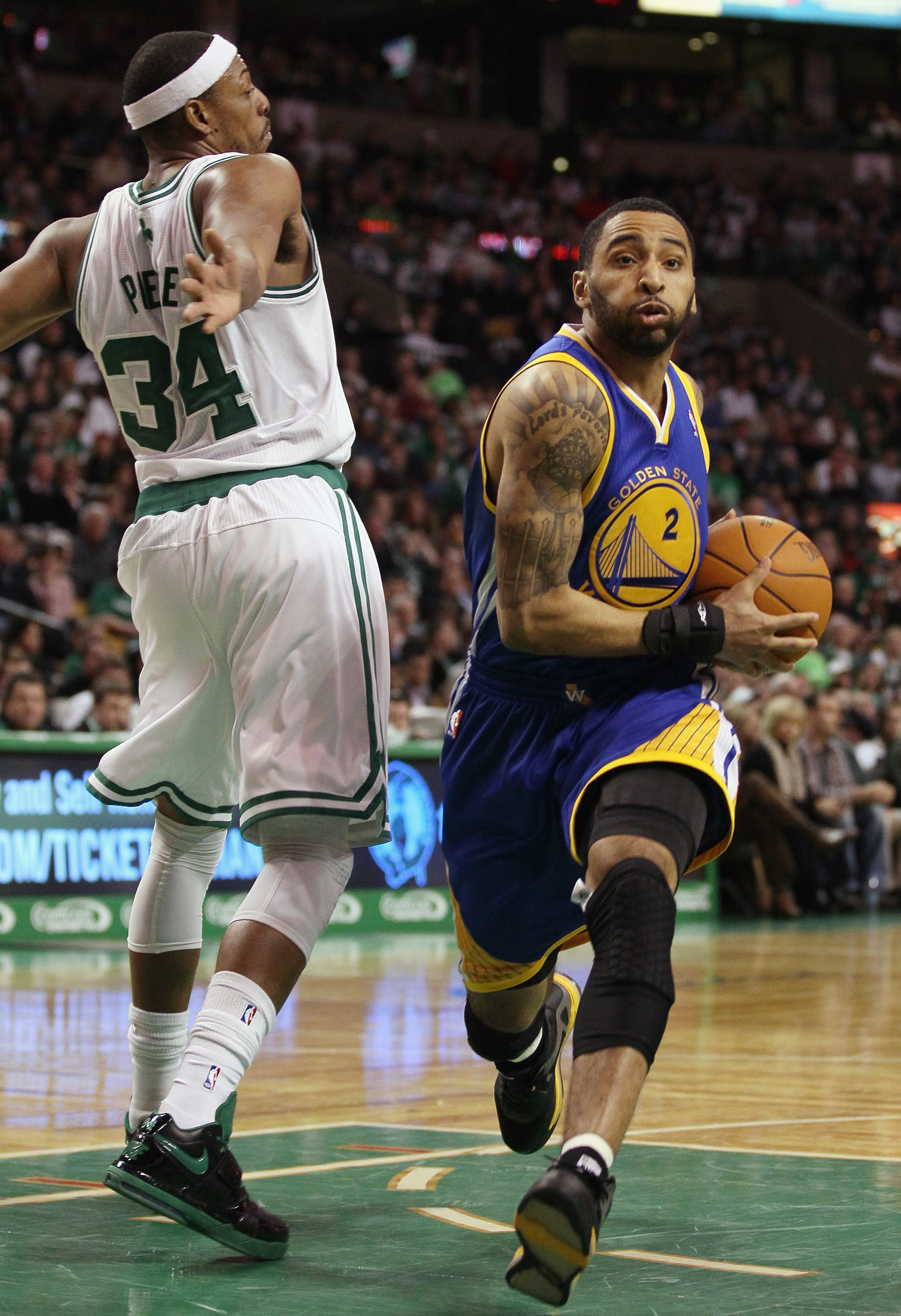 BOSTON, MA - MARCH 04:  Acie Law #2 of the Golden State Warriors drives pasts Paul Pierce #34 of the Boston Celtics on March 4, 2011 at the TD Garden in Boston, Massachusetts.  The Celtics defeated the Warriors 107-103. NOTE TO USER: User expressly acknow
