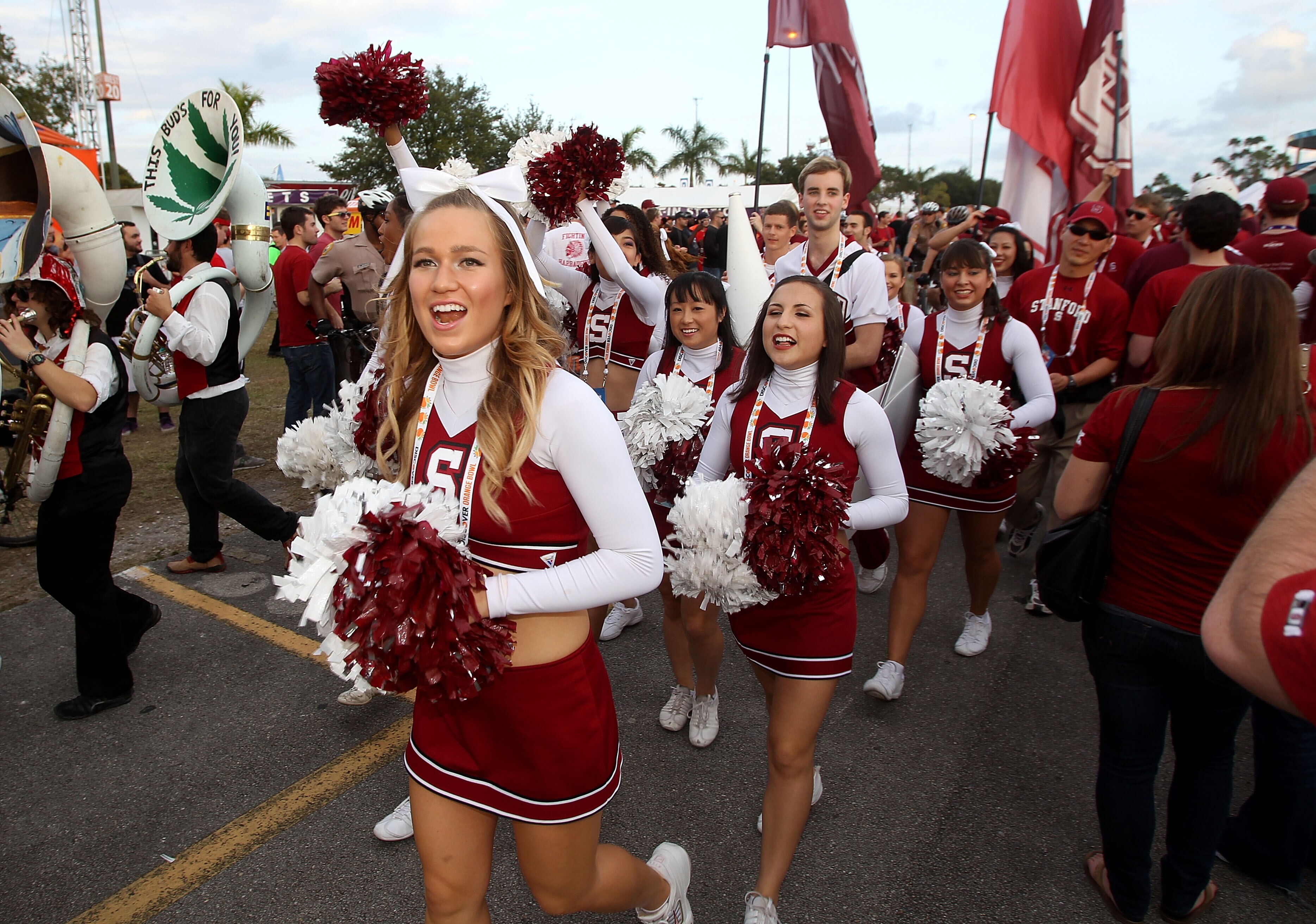 MIAMI, FL - JANUARY 03:  Cheerleaders from the Stanford Cardinal walk through the parking lot as fans tailgate prior to Stanford playing against the Virginai Tech Hokies during the 2011 Discover Orange Bowl at Sun Life Stadium on January 3, 2011 in Miami,