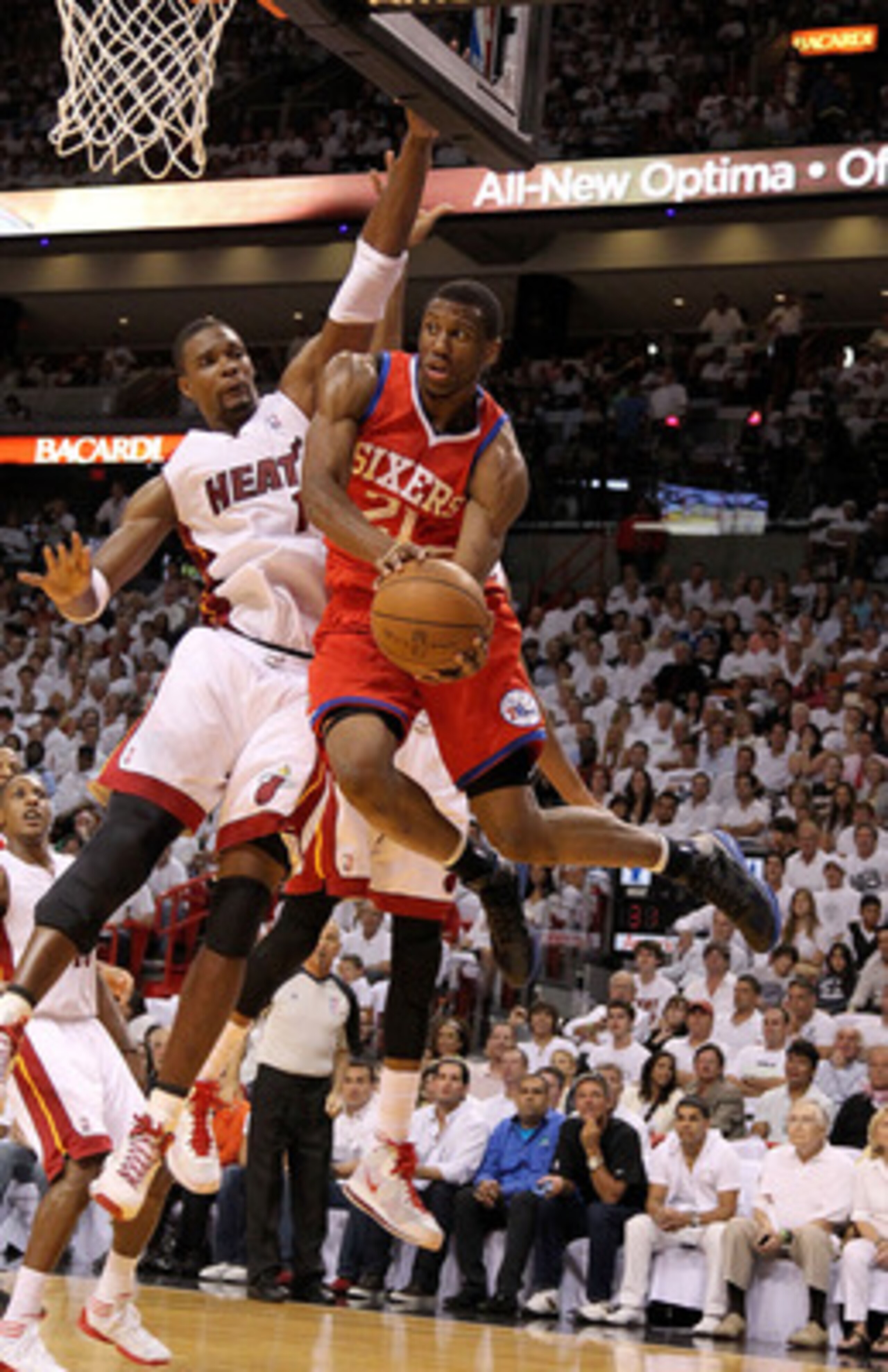 MIAMI, FL - APRIL 27:  Thaddeus Young #21 of the Philadelphia 76ers drives past Chris Bosh #1 of the Miami Heat during game five of the Eastern Conference Quarterfinals in the 2011 NBA Playoffs at American Airlines Arena on April 27, 2011 in Miami, Florid
