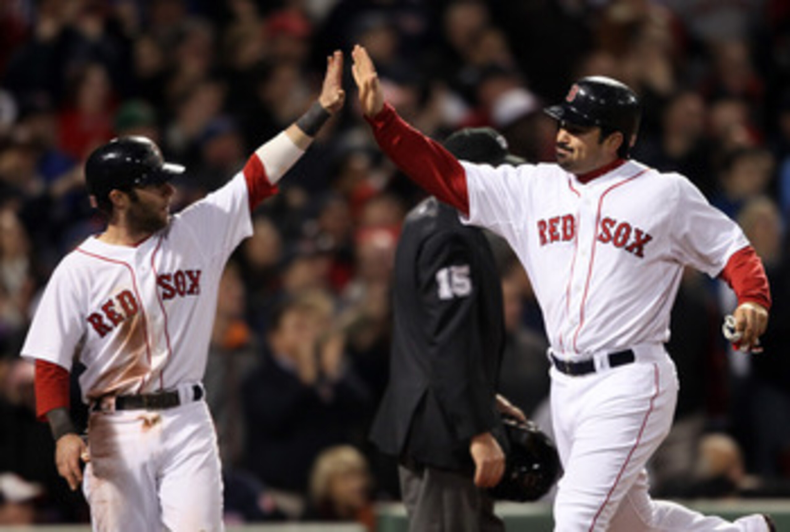 BOSTON, MA - MAY 22:  Dustin Pedroia #15 and Adrian Gonzalez #28 of the Boston Red Sox celebrate after they scored in the seventh inning against the Chicago Cubs on May 22, 2011 at Fenway Park in Boston, Massachusetts.  Before this series, the two teams h