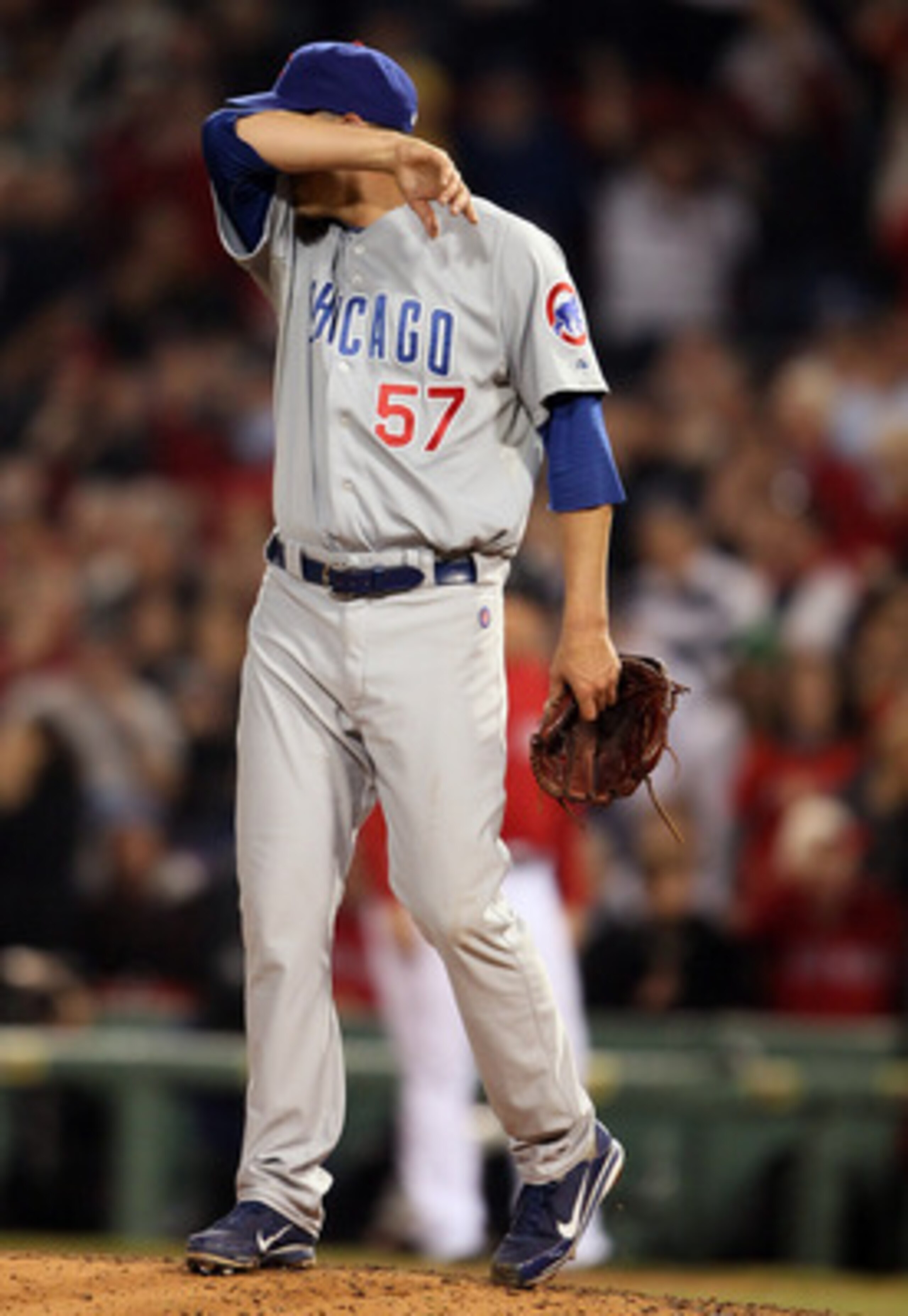 BOSTON, MA - MAY 20:  Scott Maine #57 of the Chicago Cubs wipes his brow after giving up a solo home run to Jarrod Saltalamacchia of the Boston Red Sox on May 20, 2011 at Fenway Park in Boston, Massachusetts.on May 20, 2011 at Fenway Park in Boston, Massa
