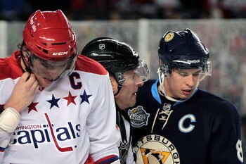 PITTSBURGH, PA - JANUARY 01:  Alex Ovechkin #8 of the Washington Capitals and Sidney Crosby #81 of the Pittsburgh Penguins are seperated by a referee during the 2011 NHL Bridgestone Winter Classic at Heinz Field on January 1, 2011 in Pittsburgh, Pennsylva