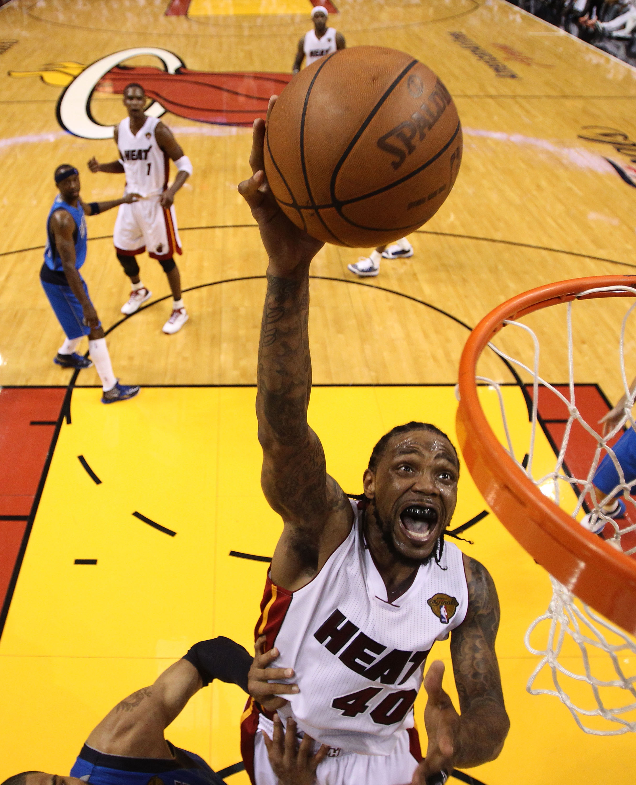 MIAMI, FL - MAY 31:  Udonis Haslem #40 of the Miami Heat goes up for a shot over Tyson Chandler #6 of the Dallas Mavericks in the fourth quarter in Game One of the 2011 NBA Finals at American Airlines Arena on May 31, 2011 in Miami, Florida. NOTE TO USER:
