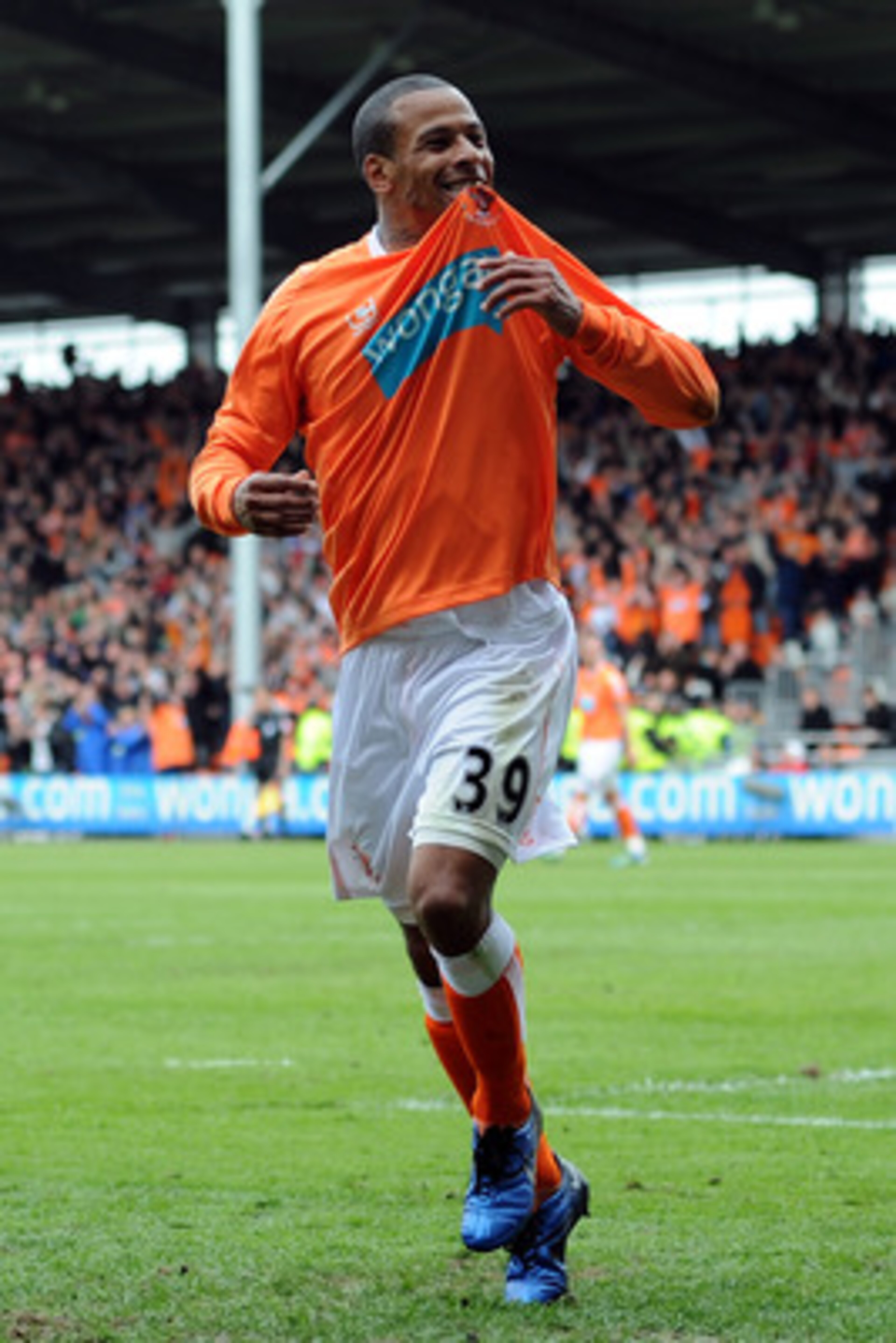 BLACKPOOL, ENGLAND - MAY 14:  DJ Campbell of Blackpool celebrates after scoring his side's third goal during the Barclays Premier League match between Blackpool and Bolton Wanderers at Bloomfield Road on May 14, 2011 in Blackpool, England.  (Photo by Chri