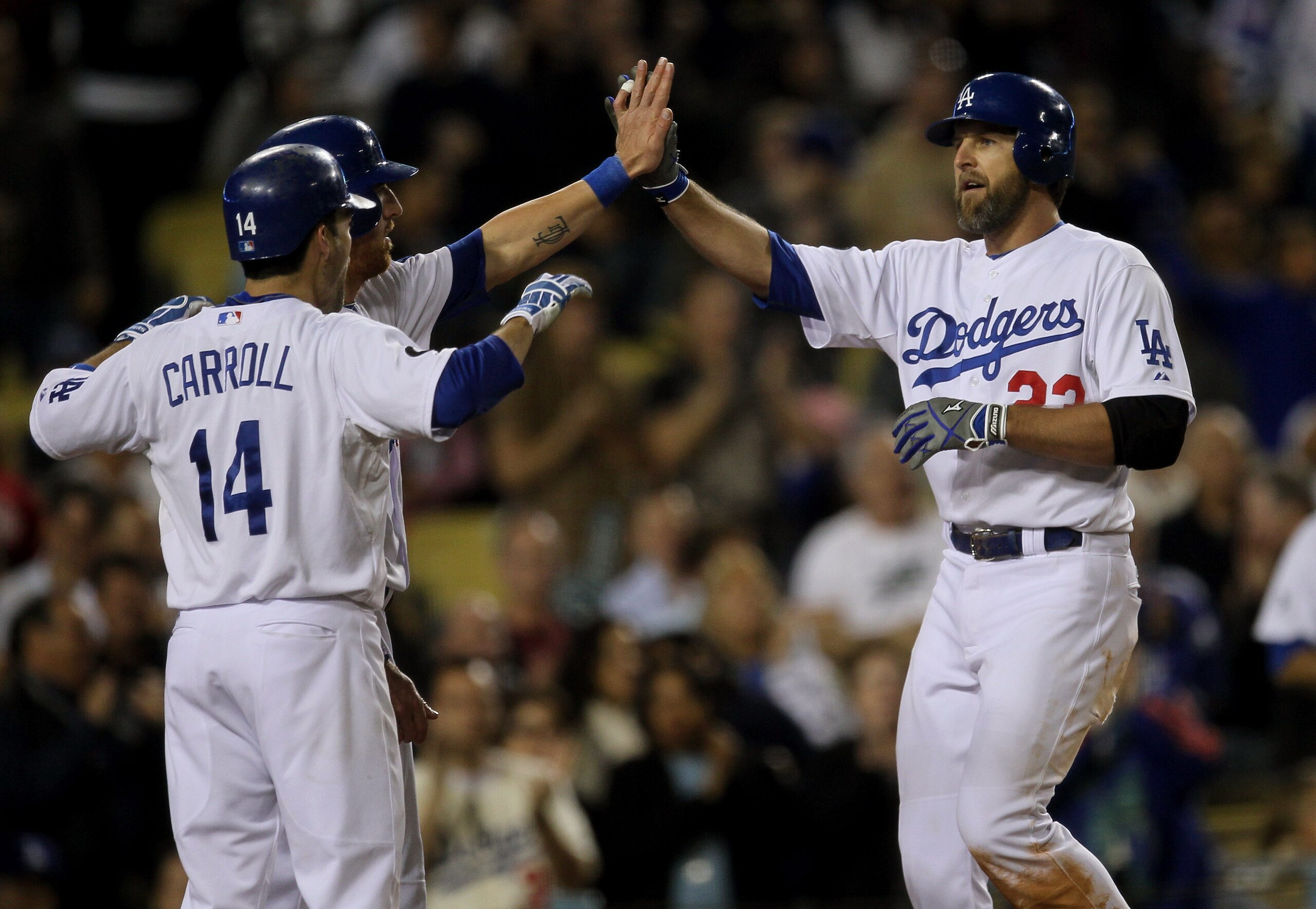 LOS ANGELES, CA - MAY 31:  Casey Blake #23 of the Los Angeles Dodgers is greeted by Jay Gibbons #31 and Jamey Carroll #14 as all three score on Blake's three run home run in the seventh inning against the Colorado Rockies on May 31, 2011 at Dodger Stadium