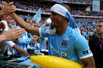 LONDON, ENGLAND - MAY 14:   Vincent Kompany of Manchester City celebrates victory with the fans at the end of the FA Cup sponsored by E.ON Final match between Manchester City and Stoke City at Wembley Stadium on May 14, 2011 in London, England.  (Photo by
