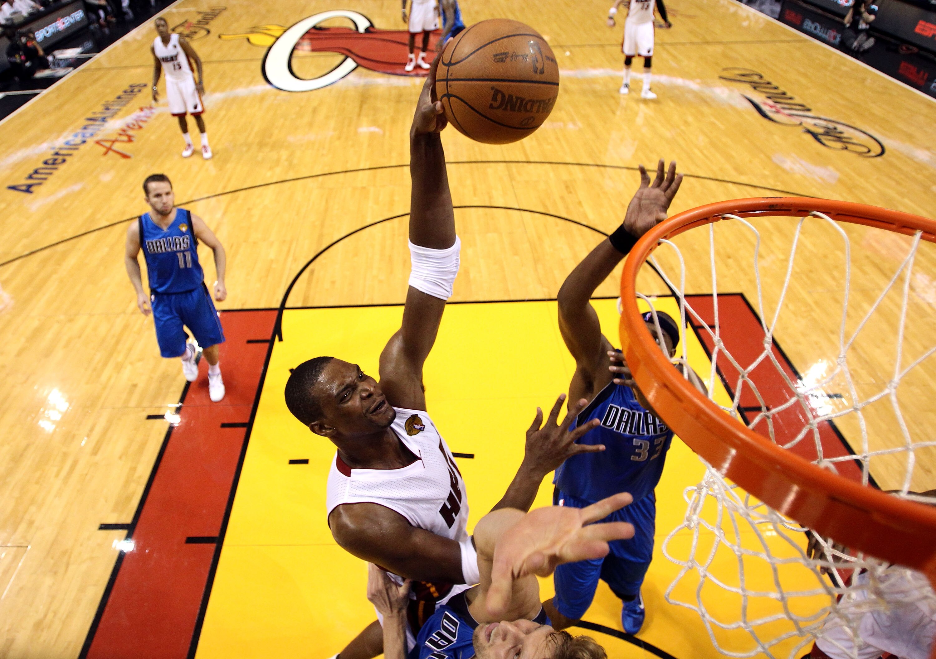 MIAMI, FL - MAY 31:  Chris Bosh #1 of the Miami Heat goes up for a dunk over Dirk Nowitzki #41 of the Dallas Mavericks in the second half in Game One of the 2011 NBA Finals at American Airlines Arena on May 31, 2011 in Miami, Florida. NOTE TO USER: User e