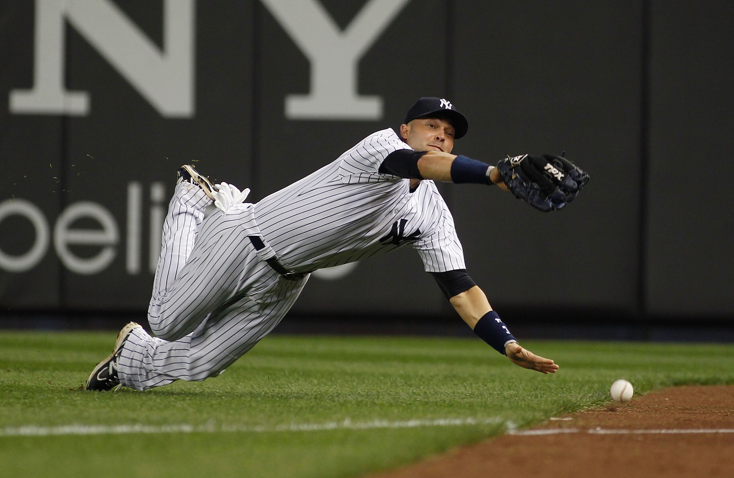 NEW YORK - MAY 20:  Nick Swisher #33 of the New York Yankees dives and misses Justin Turner #2 of the New York Mets (not pictured) ground rule double on May 20, 2011 at Yankee Stadium in the Bronx borough of New York City.  (Photo by Mike Stobe/Getty Imag