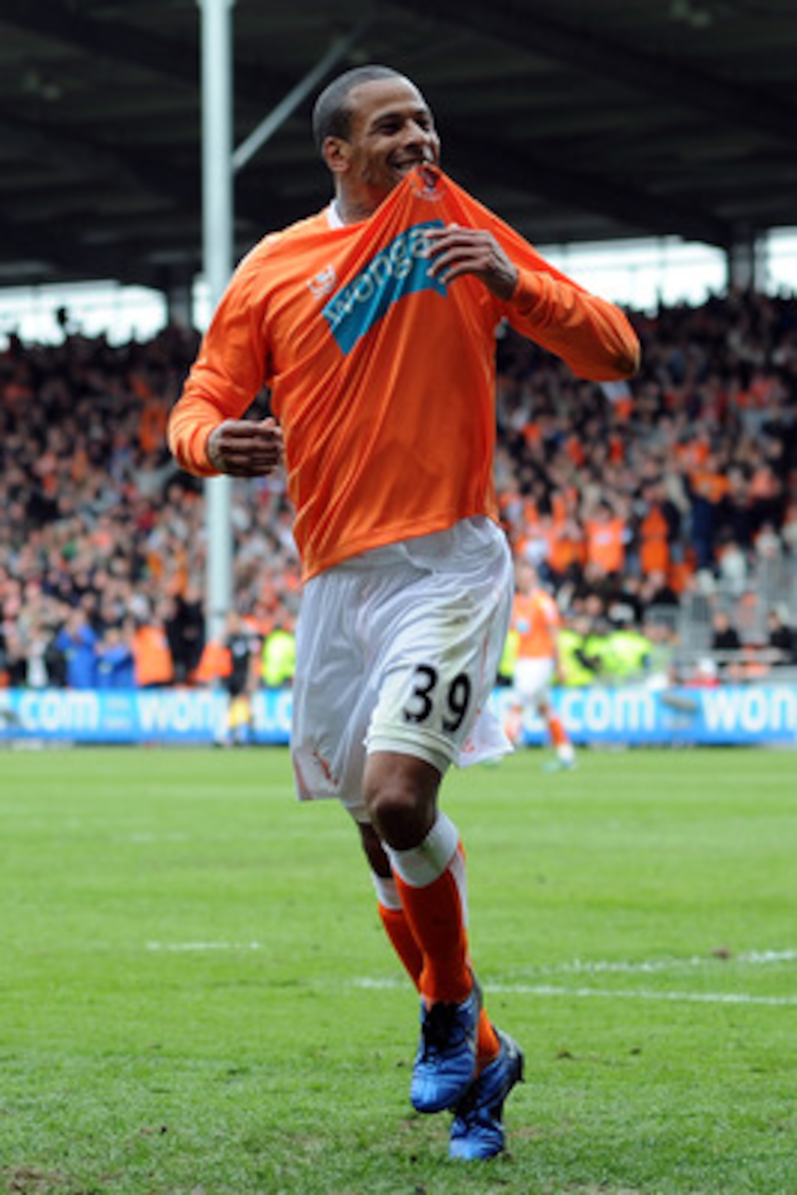 BLACKPOOL, ENGLAND - MAY 14:  DJ Campbell of Blackpool celebrates after scoring his side's third goal during the Barclays Premier League match between Blackpool and Bolton Wanderers at Bloomfield Road on May 14, 2011 in Blackpool, England.  (Photo by Chri