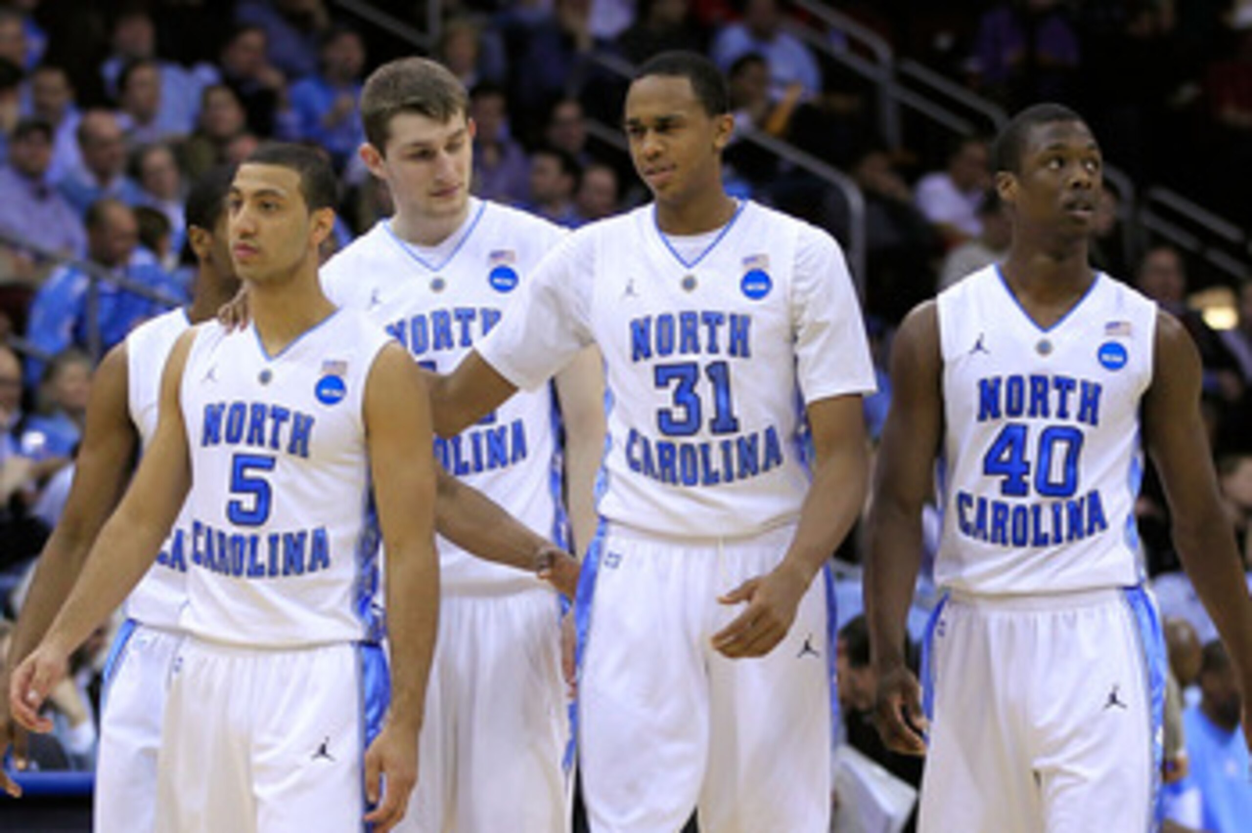 NEWARK, NJ - MARCH 25:  Dexter Strickland #1, Kendall Marshall #5, John Henson #31 and Harrison Barnes #40  of the North Carolina Tar Heels walk on the court after a play against the Marquette Golden Eagles during the east regional semifinal of the 2011 N