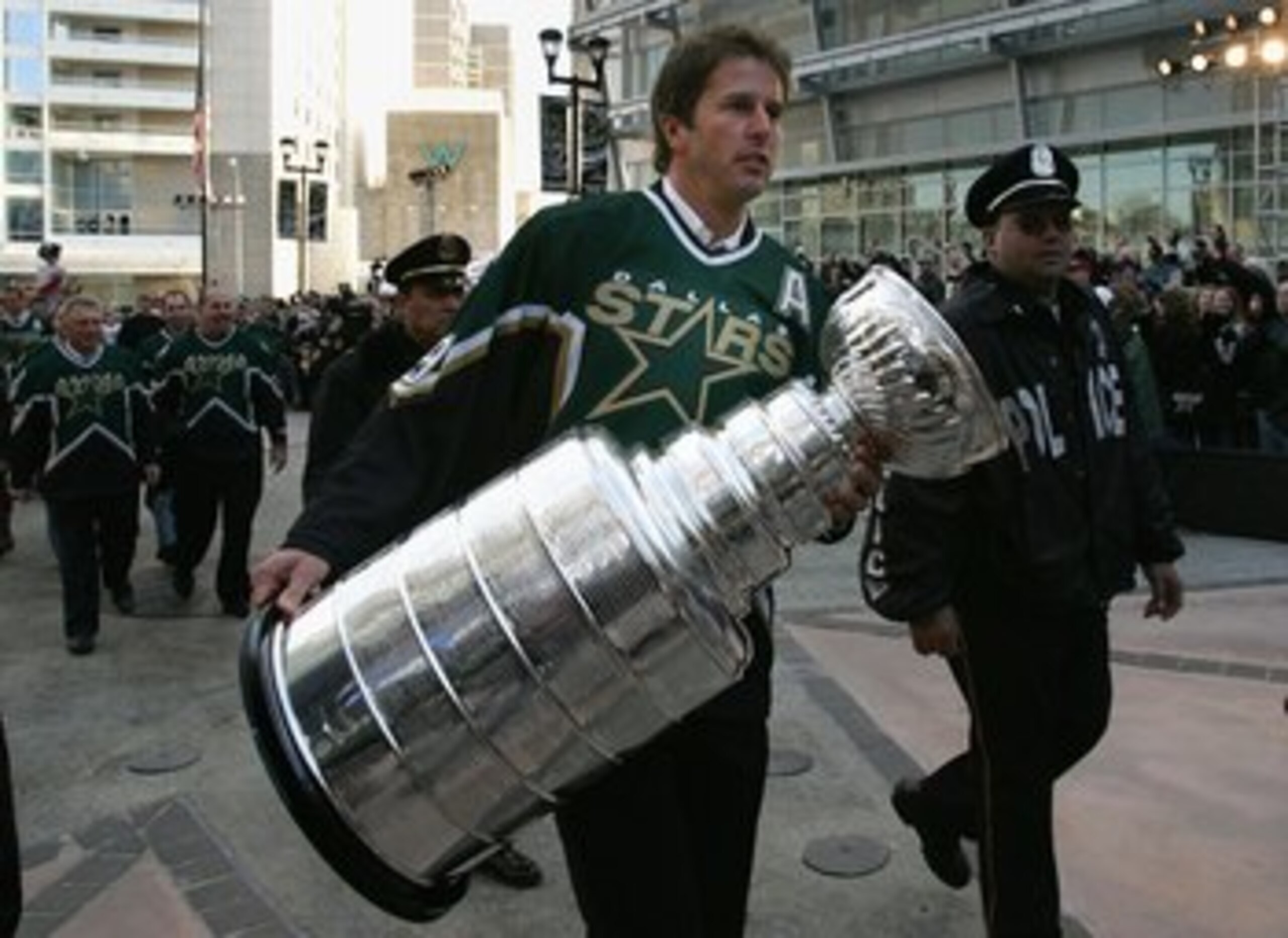 DALLAS - JANUARY 22:  Mike Modano #9 of the 1999 Dallas Stars Stanley Cup team walks with the Stanley Cup during the 1999 Dallas Stars Stanley Cup Reunion at the American Airlines Center on January 22, 2007 in Dallas, Texas.  (Photo by Bruce Bennett/Getty