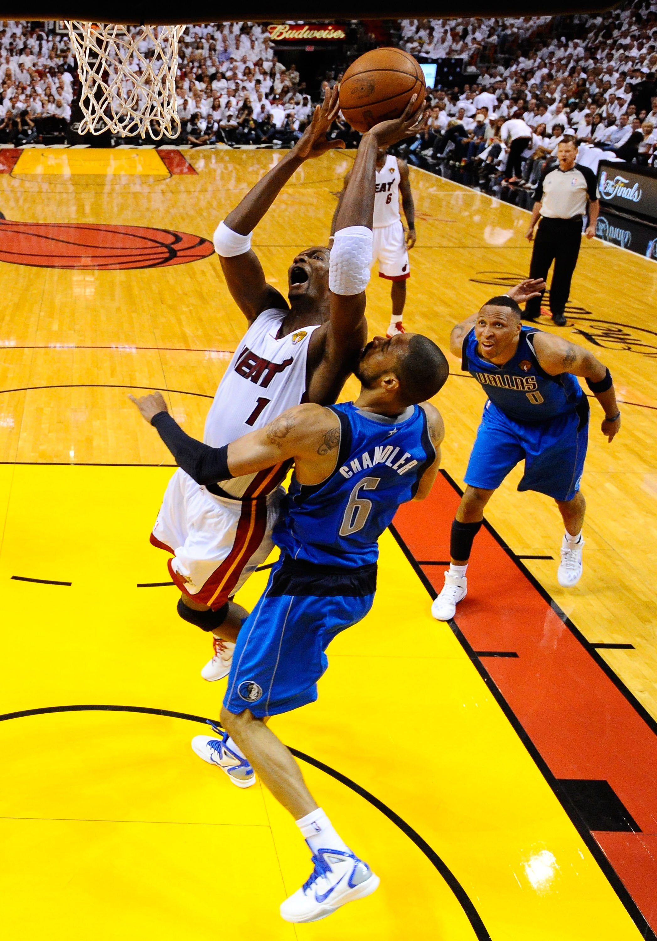 MIAMI, FL - MAY 31:  Chris Bosh #1 of the Miami Heat drives for a shot attempt against Tyson Chandler #6 of the Dallas Mavericks in Game One of the 2011 NBA Finals at American Airlines Arena on May 31, 2011 in Miami, Florida. NOTE TO USER: User expressly