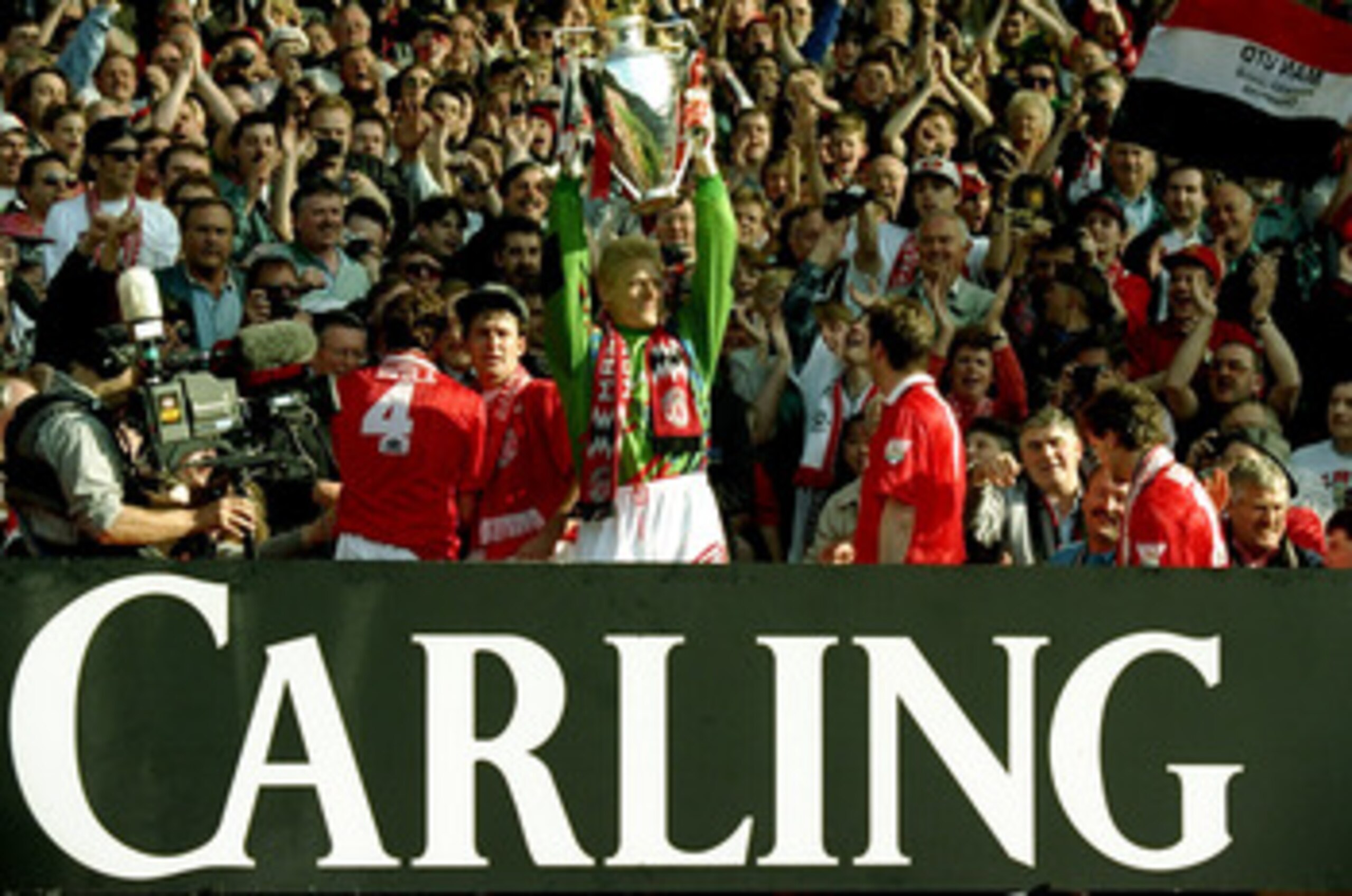 8 May 1994:  Peter Schmeichel of Manchester United celebrates with the premiership trophy after clinching the title during the FA Carling Premiership match against Blackburn Rovers played at Old Trafford in Manchester, England. \ Mandatory Credit: David C
