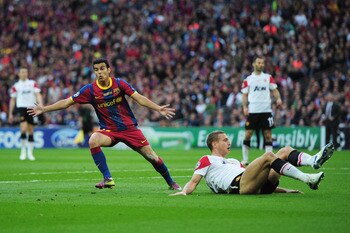 LONDON, ENGLAND - MAY 28:  Pedro of FC Barcelona (L) celebrates scoring the opening goal as Nemanja Vidic of Manchester United lies on the ground during the UEFA Champions League final between FC Barcelona and Manchester United FC at Wembley Stadium on Ma