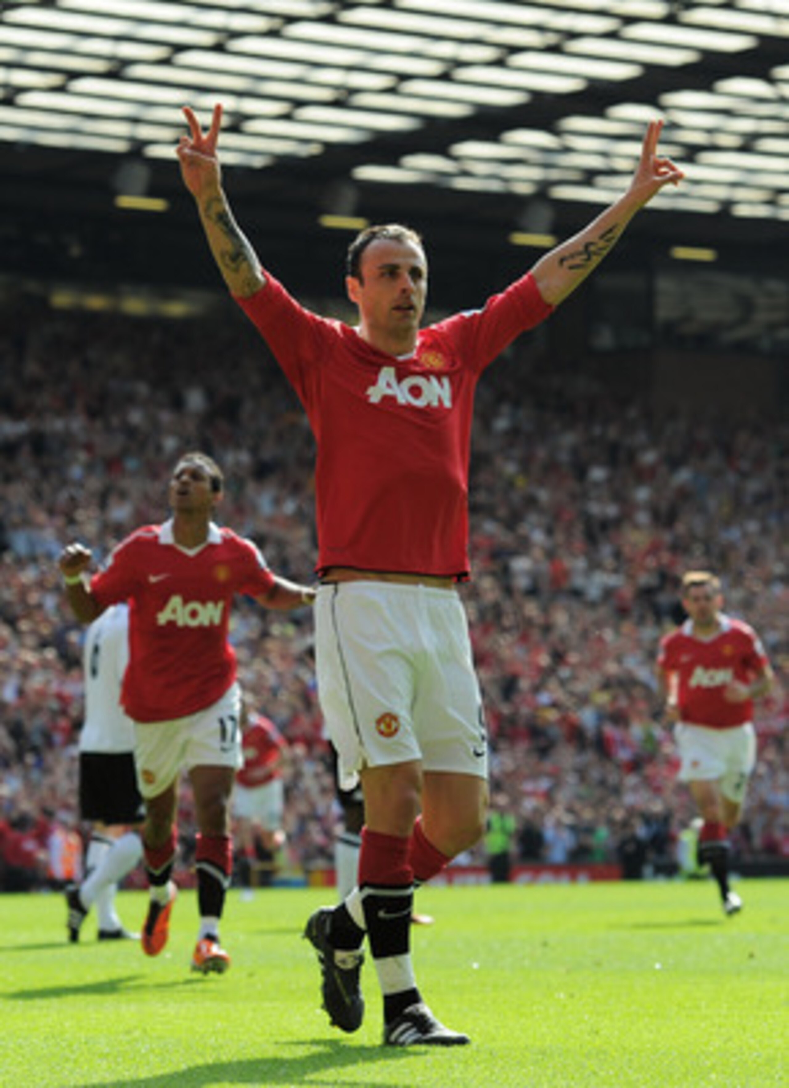 MANCHESTER, ENGLAND - APRIL 09:  Dimitar Berbatov of Manchester United celebrates scoring the opening goal during the Barclays Premier League match between Manchester United and Fulham at Old Trafford on April 9, 2011 in Manchester, England.  (Photo by Mi