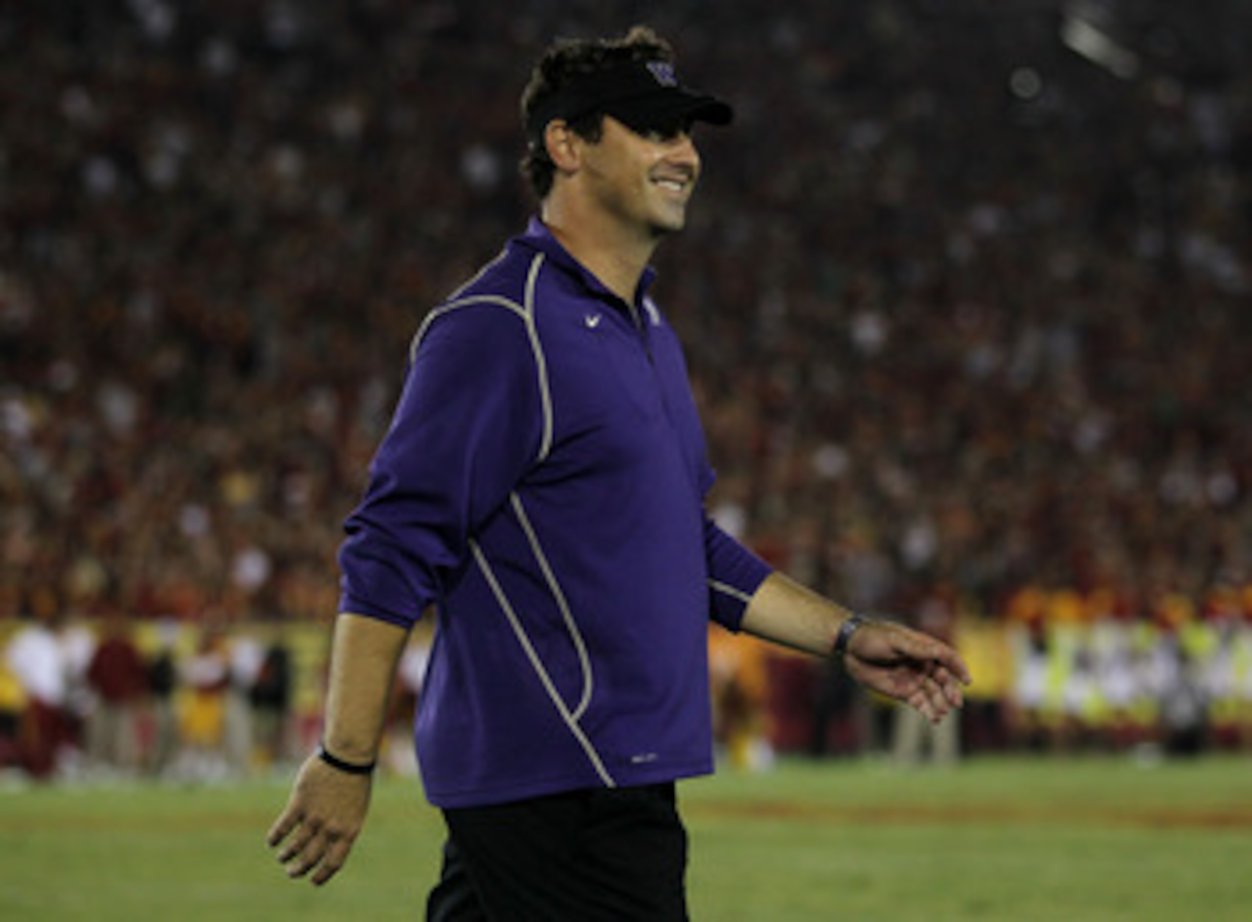 LOS ANGELES - OCTOBER 2:  Head coach Steve Sarkisian of the Washington Huskies smiles during a time out before the Huskies kicked the game winning field goal against the USC Trojans at the  Angeles Memorial Coliseum on October 2, 2010 in Los Angeles, Cali