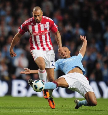 MANCHESTER, ENGLAND - MAY 17:  John Carew of Stoke City is tackled by Vincent Kompany of Manchester City during the Barclays Premier League match between Manchester City and Stoke City at City of Manchester Stadium on May 17, 2011 in Manchester, England.
