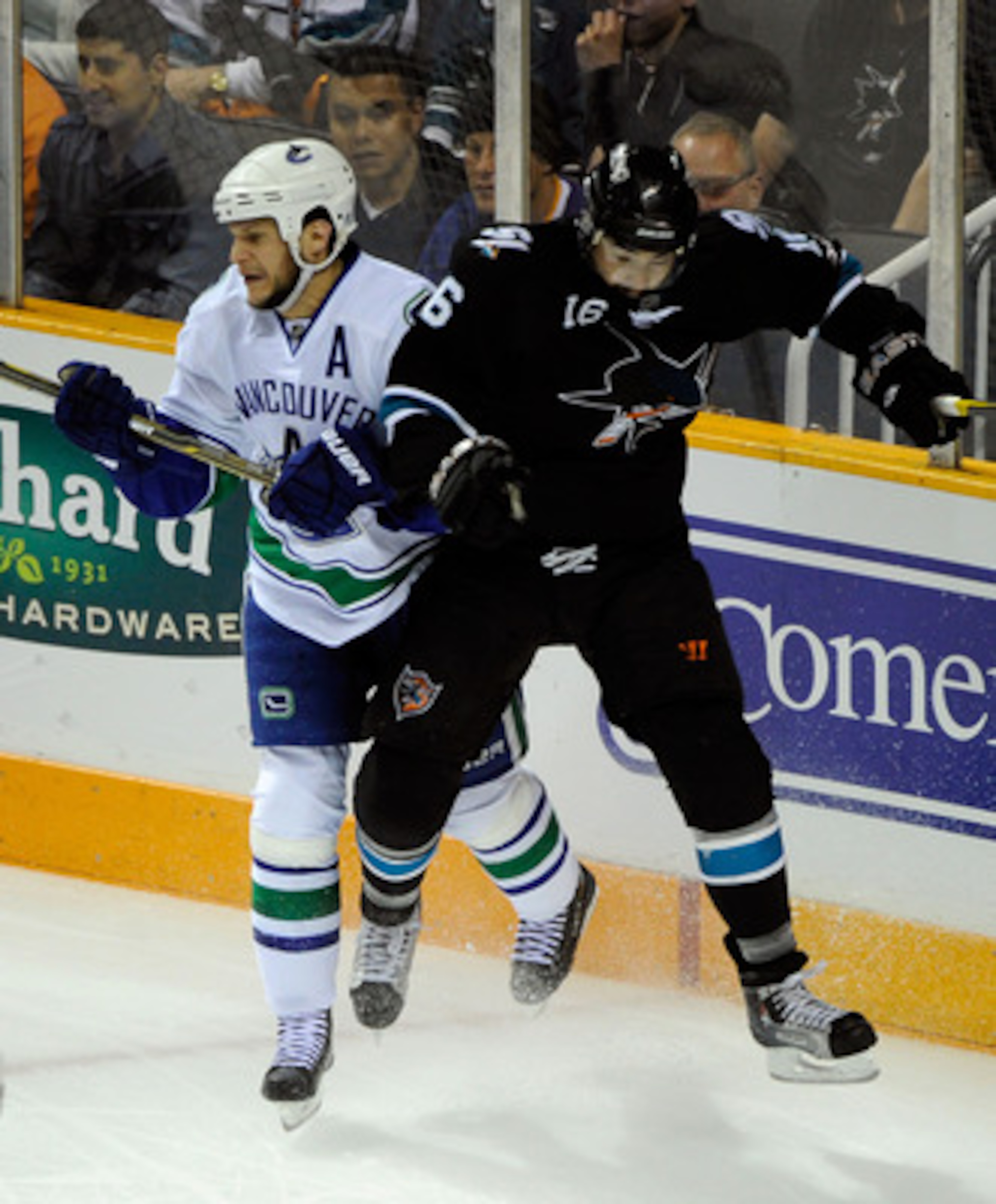 SAN JOSE, CA - MAY 20:  Kevin Bieksa #3 of the Vancouver Canucks and Devin Setoguchi #16 of the San Jose Sharks collide near the corner in Game Three of the Western Conference Finals during the 2011 Stanley Cup Playoffs at HP Pavilion on May 20, 2011 in S