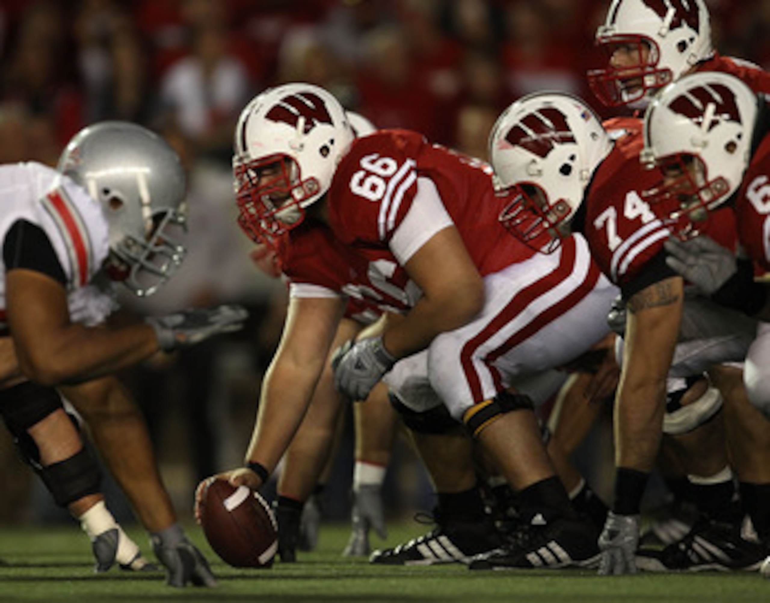 MADISON, WI - OCTOBER 16: Peter Konz #66 of the Wisconsin Badgers prepares to snap the ball to Scott Tolzien #16 against the Ohio State Buckeyes at Camp Randall Stadium on October 16, 2010 in Madison, Wisconsin. Wisconsin defeated Ohio State 31-18. (Photo