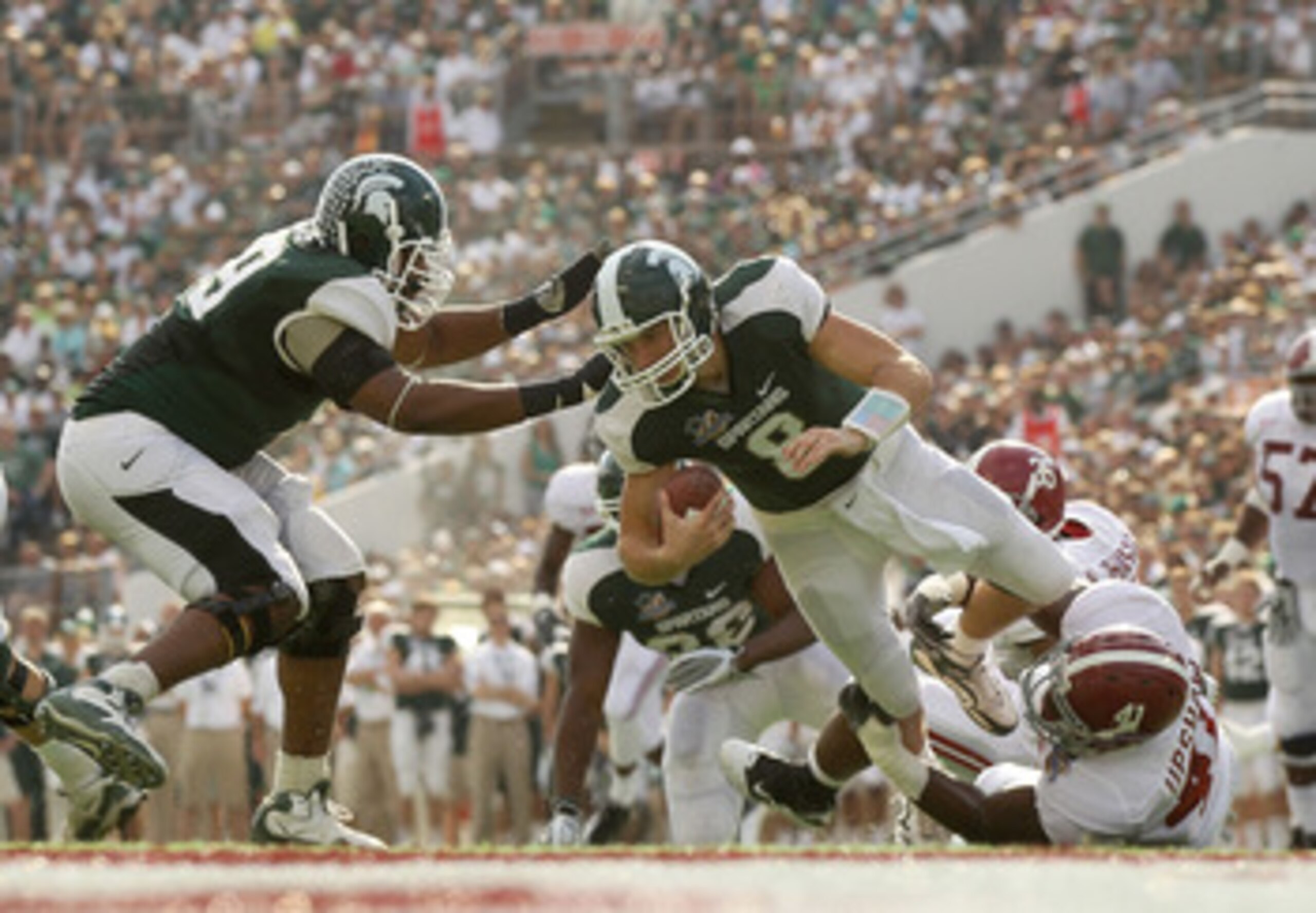 ORLANDO, FL - JANUARY 01:  Kirk Cousins #8  of the Michigan State Spartans is sacked by Courtney Upshaw #41 of the Alabama Crimson Tide during the Capitol One Bowl at the Florida Citrus Bowl on January 1, 2011 in Orlando, Florida.  (Photo by Mike Ehrmann/