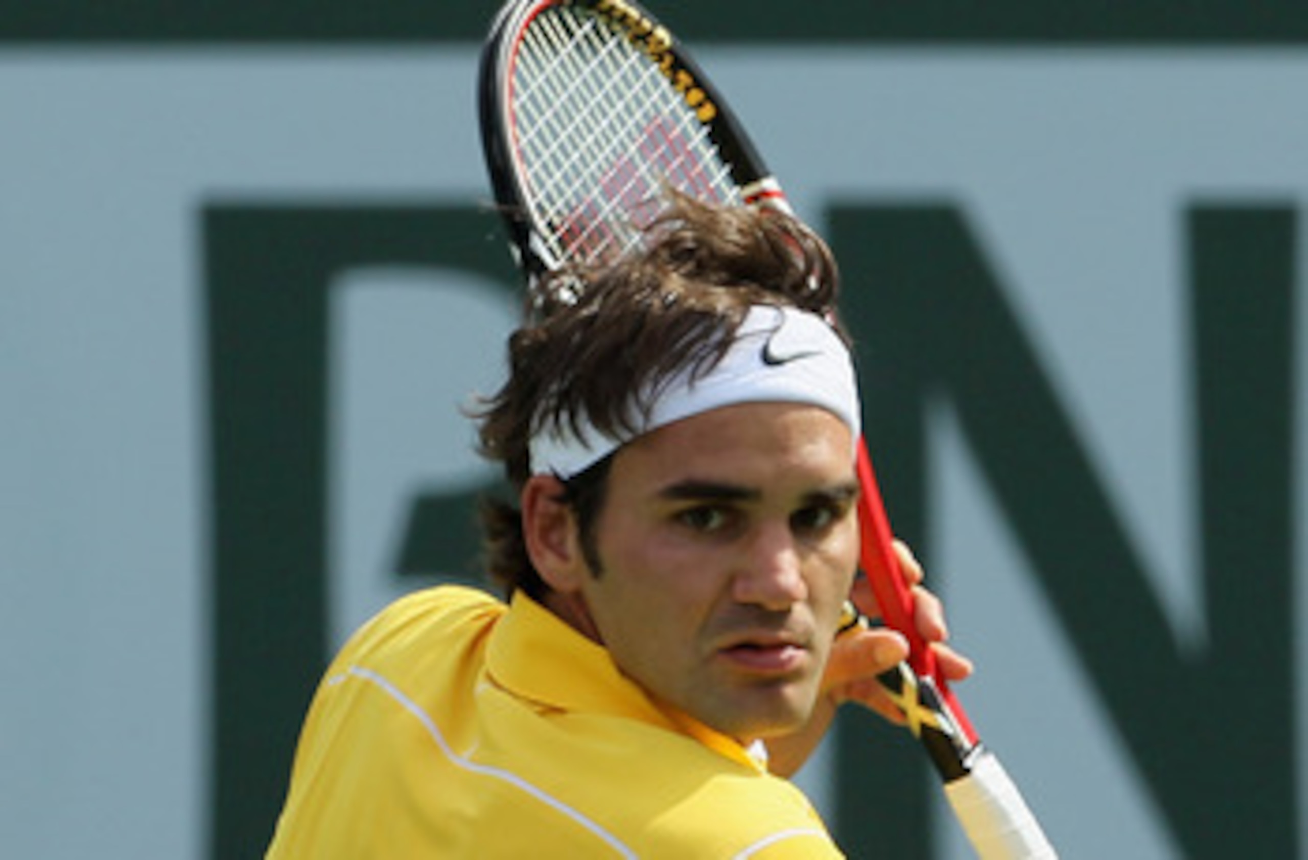 INDIAN WELLS, CA - MARCH 19:  Roger Federer of Switzerland returns a backhand to Novak Djokovic of Serbia during the semifinals of the BNP Paribas Open at the Indian Wells Tennis Garden on March 19, 2011 in Indian Wells, California.  (Photo by Jeff Gross/