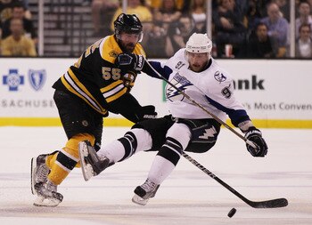BOSTON, MA - MAY 27:  Johnny Boychuk #55 of the Boston Bruins knocks Steven Stamkos #91 of the Tampa Bay Lightning to the ice in the first period of Game Seven of the Eastern Conference Finals during the 2011 NHL Stanley Cup Playoffs at TD Garden on May 2