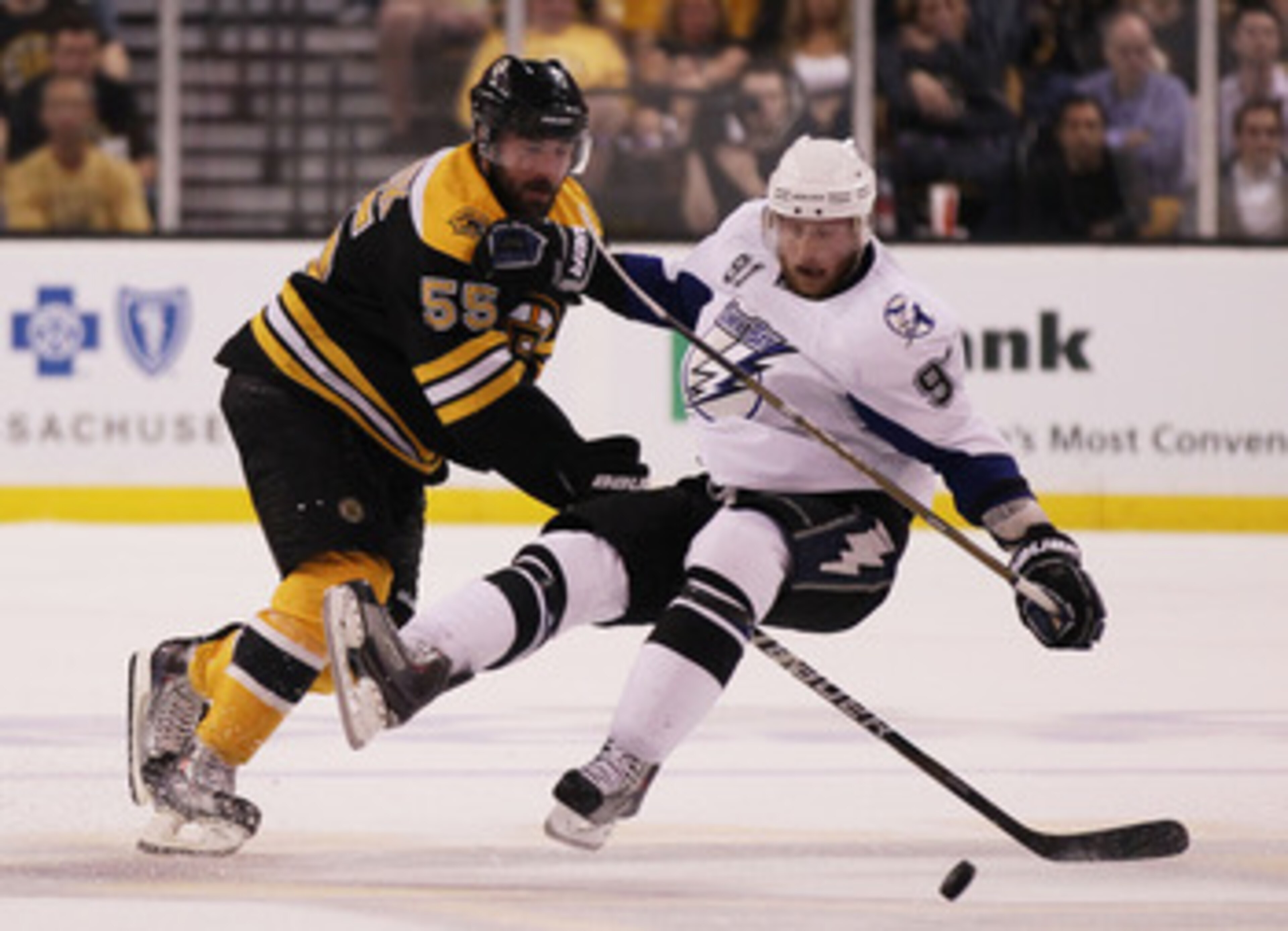 BOSTON, MA - MAY 27:  Johnny Boychuk #55 of the Boston Bruins knocks Steven Stamkos #91 of the Tampa Bay Lightning to the ice in the first period of Game Seven of the Eastern Conference Finals during the 2011 NHL Stanley Cup Playoffs at TD Garden on May 2