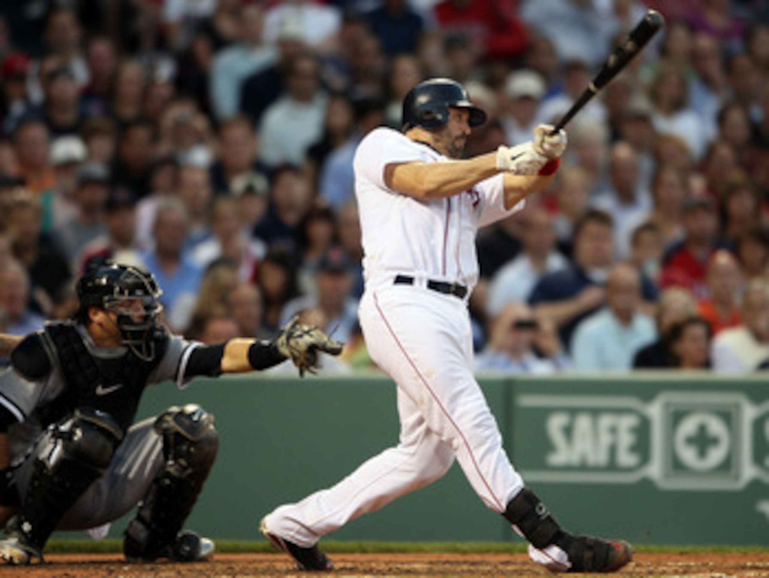 BOSTON, MA - MAY 31:  Jason Varitek #33 of the Boston Red Sox hits a solo home run in the third inning as A.J. Pierzynski #12 of the Chicago White Sox catches on May 31, 2011 at Fenway Park in Boston, Massachusetts.  (Photo by Elsa/Getty Images)
