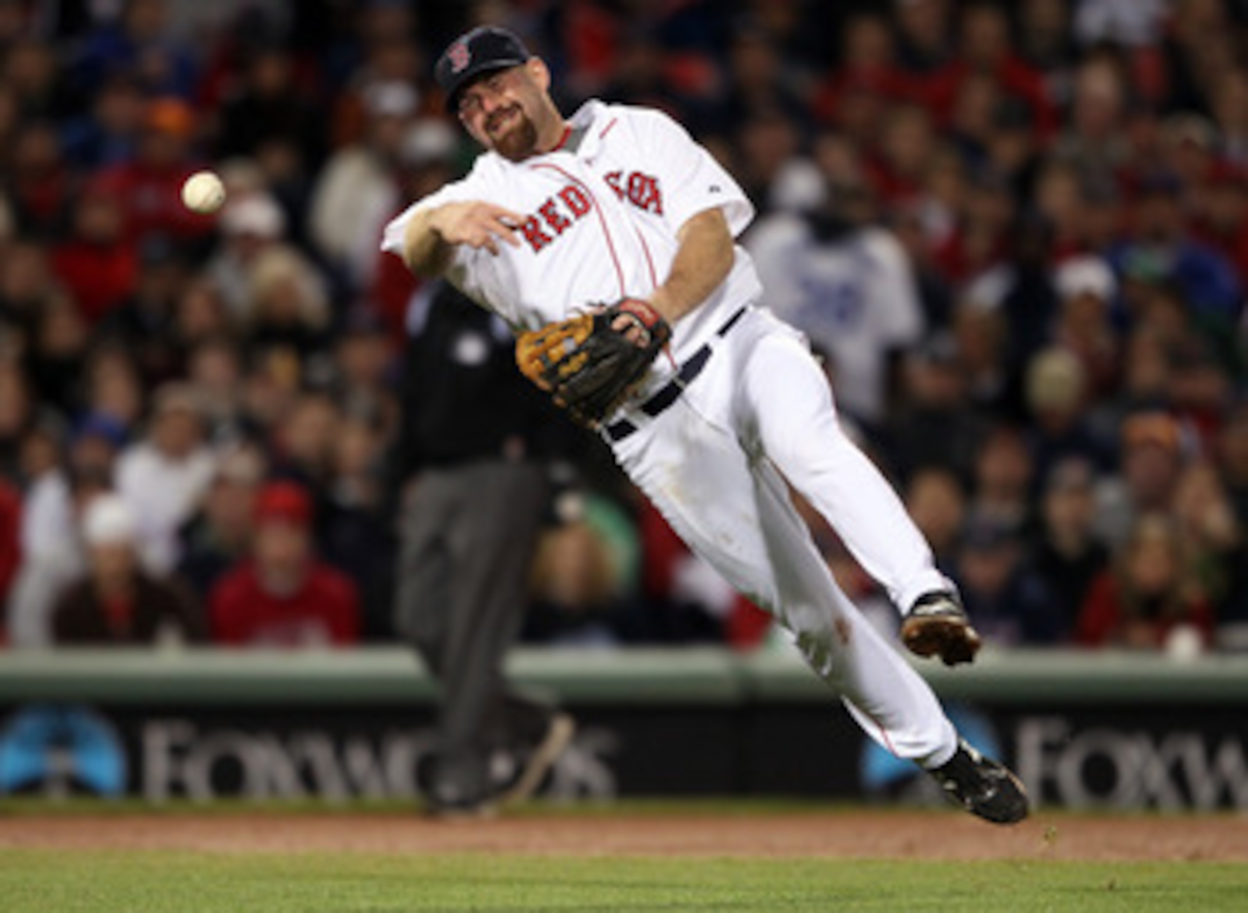 BOSTON, MA - MAY 22:  Kevin Youkilis #20 of the Boston Red Sox sends the ball to first for the out in the fifth inning against the Chicago Cubs on May 22, 2011 at Fenway Park in Boston, Massachusetts.  Before this series, the two teams haven't played at F