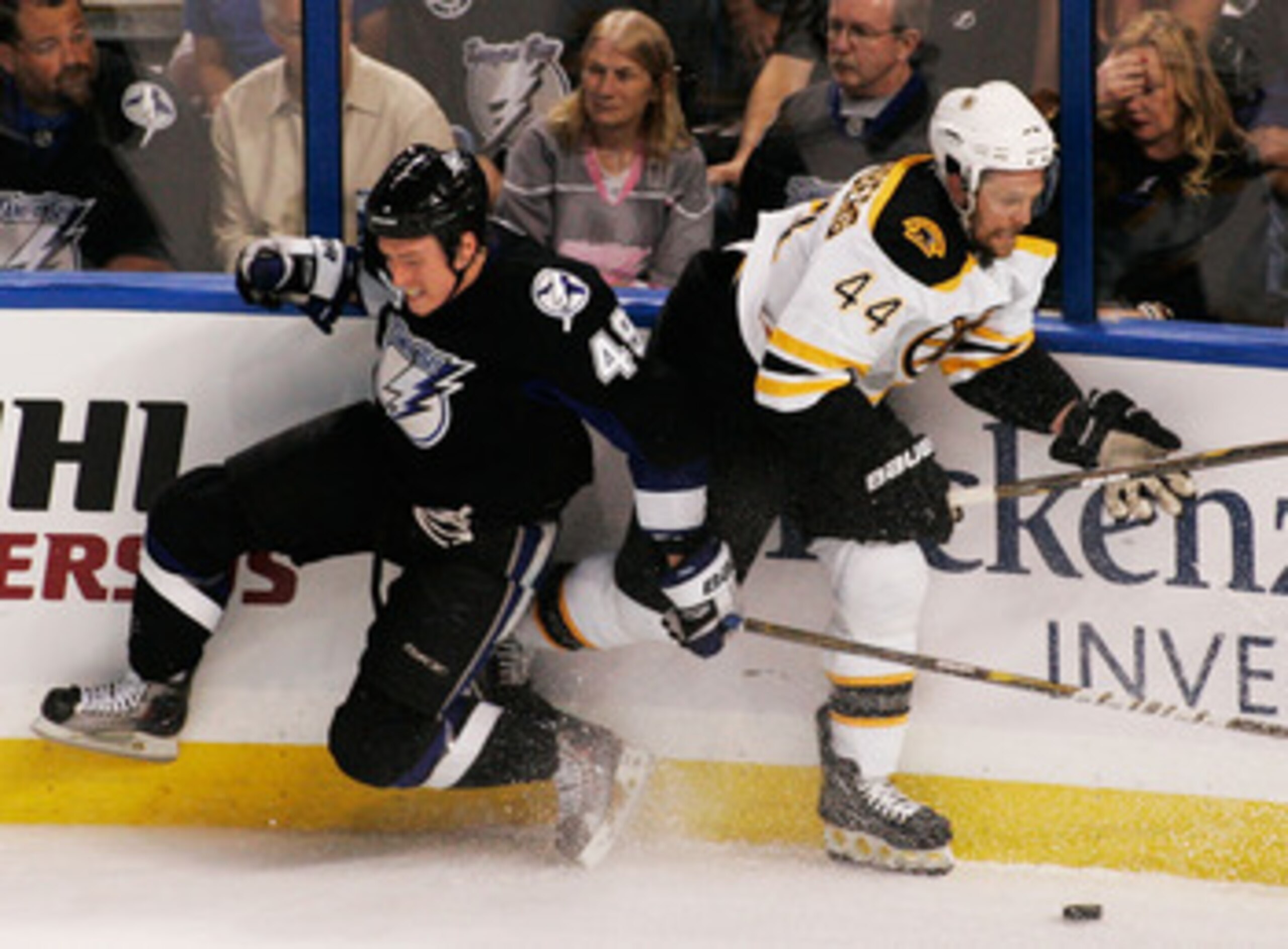 TAMPA, FL - MAY 19:  Dennis Seidenberg #44 of the Boston Bruins checks Blair Jones #49 of the Tampa Bay Lightning in Game Three of the Eastern Conference Finals during the 2011 NHL Stanley Cup Playoffs at St Pete Times Forum on May 19, 2011 in Tampa, Flor