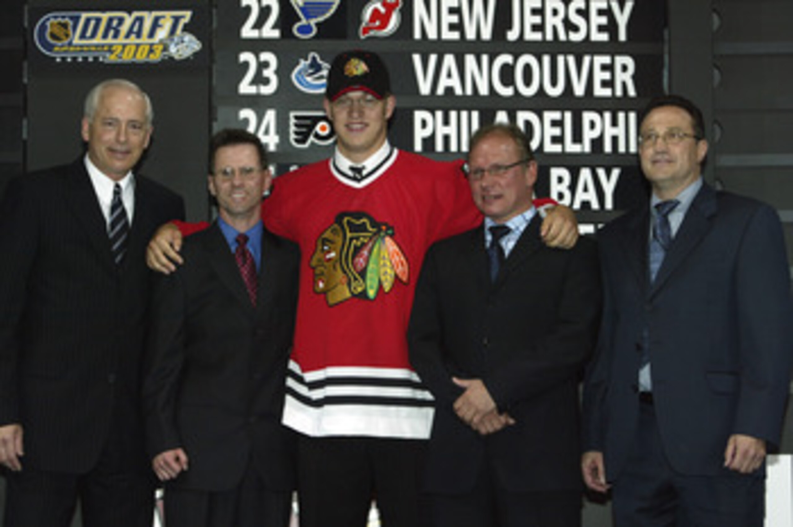 NASHVILLE, TN - JUNE 21:  (L to R) Nick Beverly, Bruce Frankliin, first round draft pick (#14 overall) Brent Seabrook, Sakari Pietila and Bill Lesuk of the Chicago Blackhawks pose for a portrait on stage during the 2003 NHL Entry Draft at the Gaylord Ente