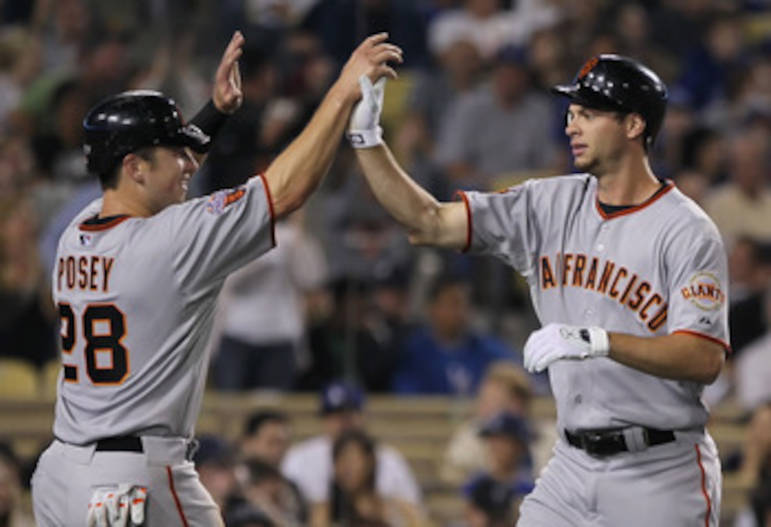 LOS ANGELES, CA - APRIL 01:  Brandon Belt (R) #9 of the San Francisco Giants is congratulated by Buster Posey #28 after hitting a three-run home run against the Los Angeles Dodgers in the fourth inning at Dodger Stadium on April 1, 2011 in Los Angeles, Ca