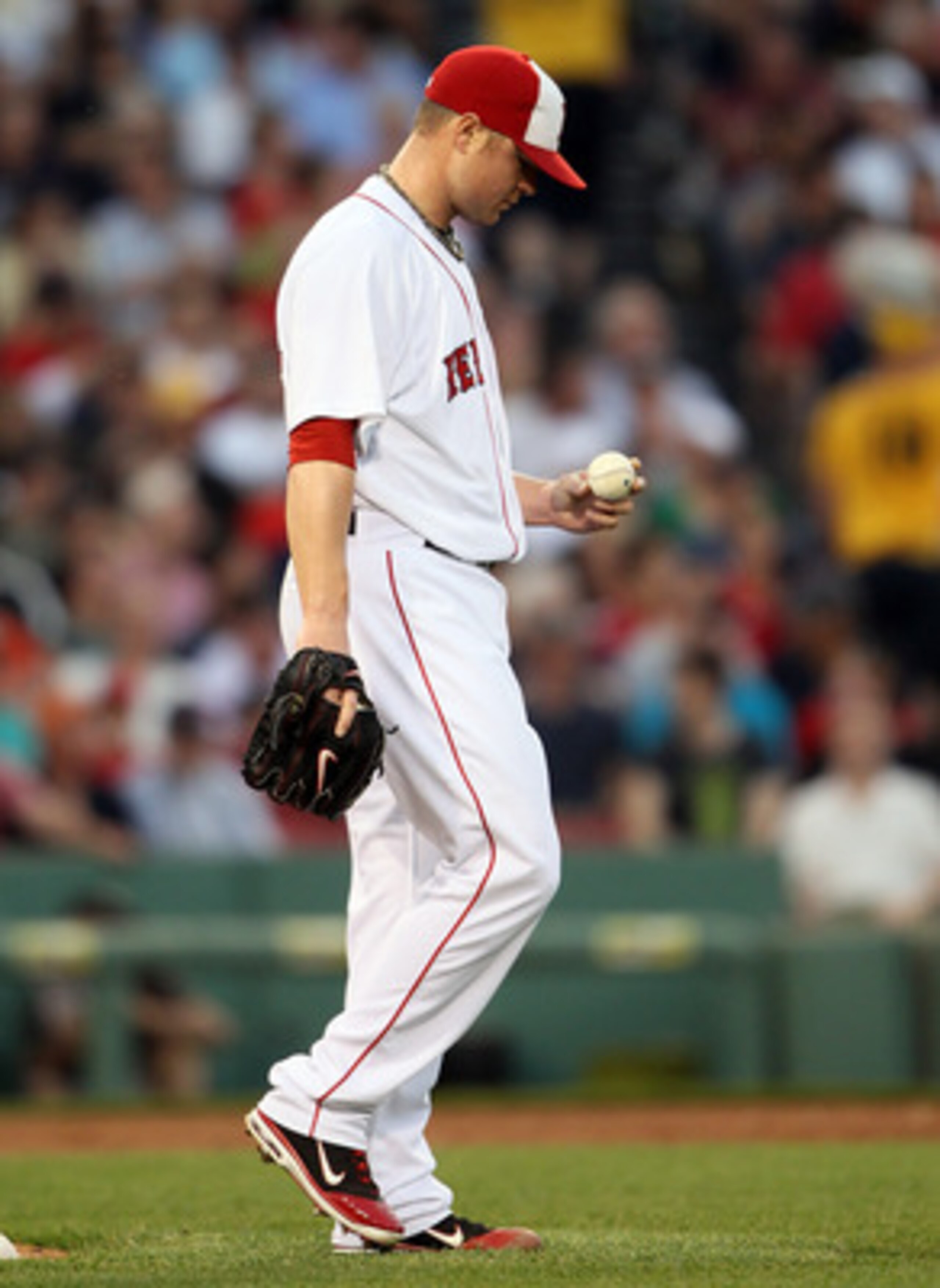 BOSTON, MA - MAY 30:  Jon Lester #31 of the Boston Red Sox reacts after giving up a solo home run to Paul Konerko of the Chicago White Sox on May 30, 2011 at Fenway Park in Boston, Massachusetts.  (Photo by Elsa/Getty Images)