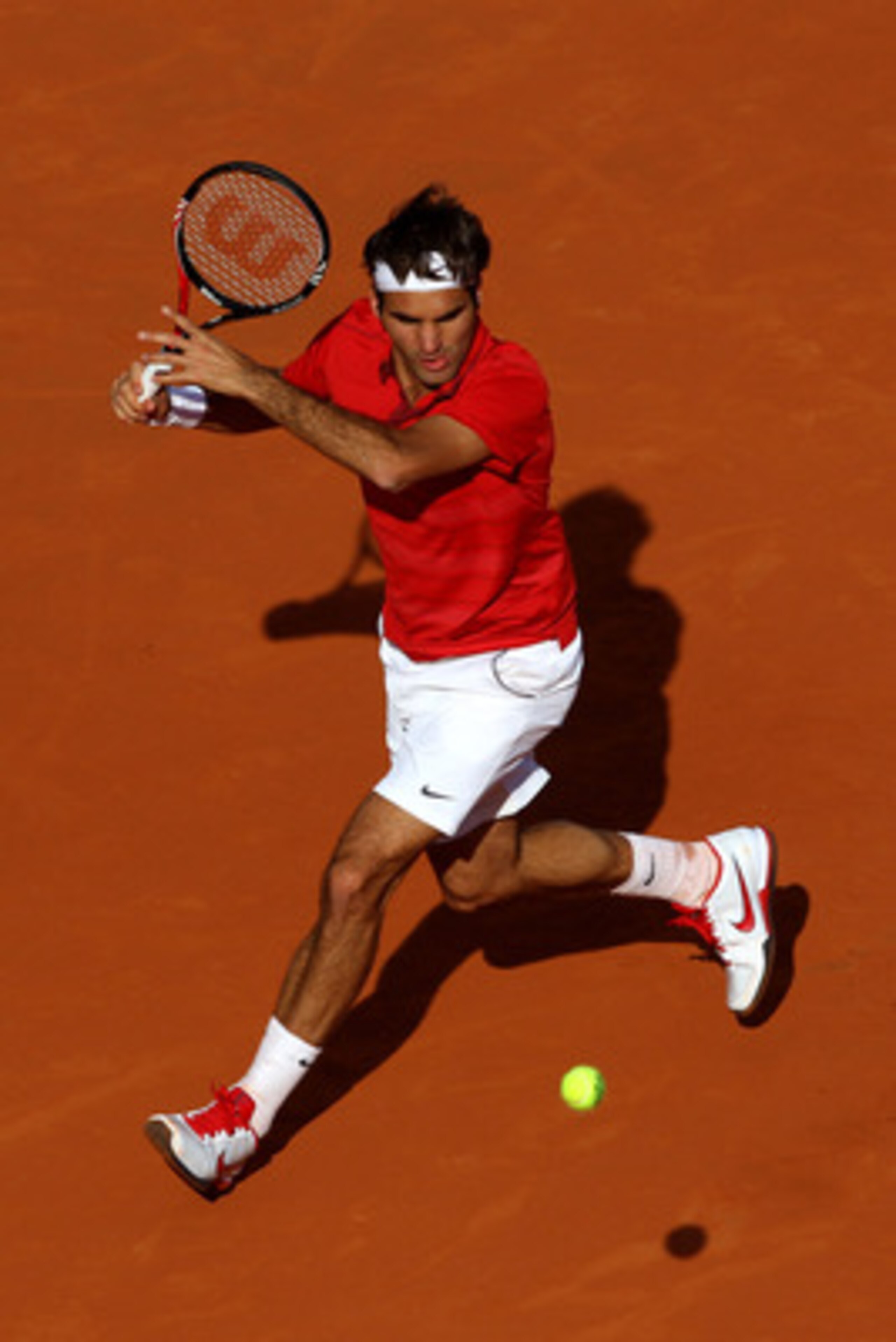 PARIS, FRANCE - MAY 31:  Roger Federer of Switzerland hits a forehand during the men's singles quarterfinal match between Gael Monfils of France and Roger Federer of Switzerland on day ten of the French Open at Roland Garros on May 31, 2011 in Paris, Fran