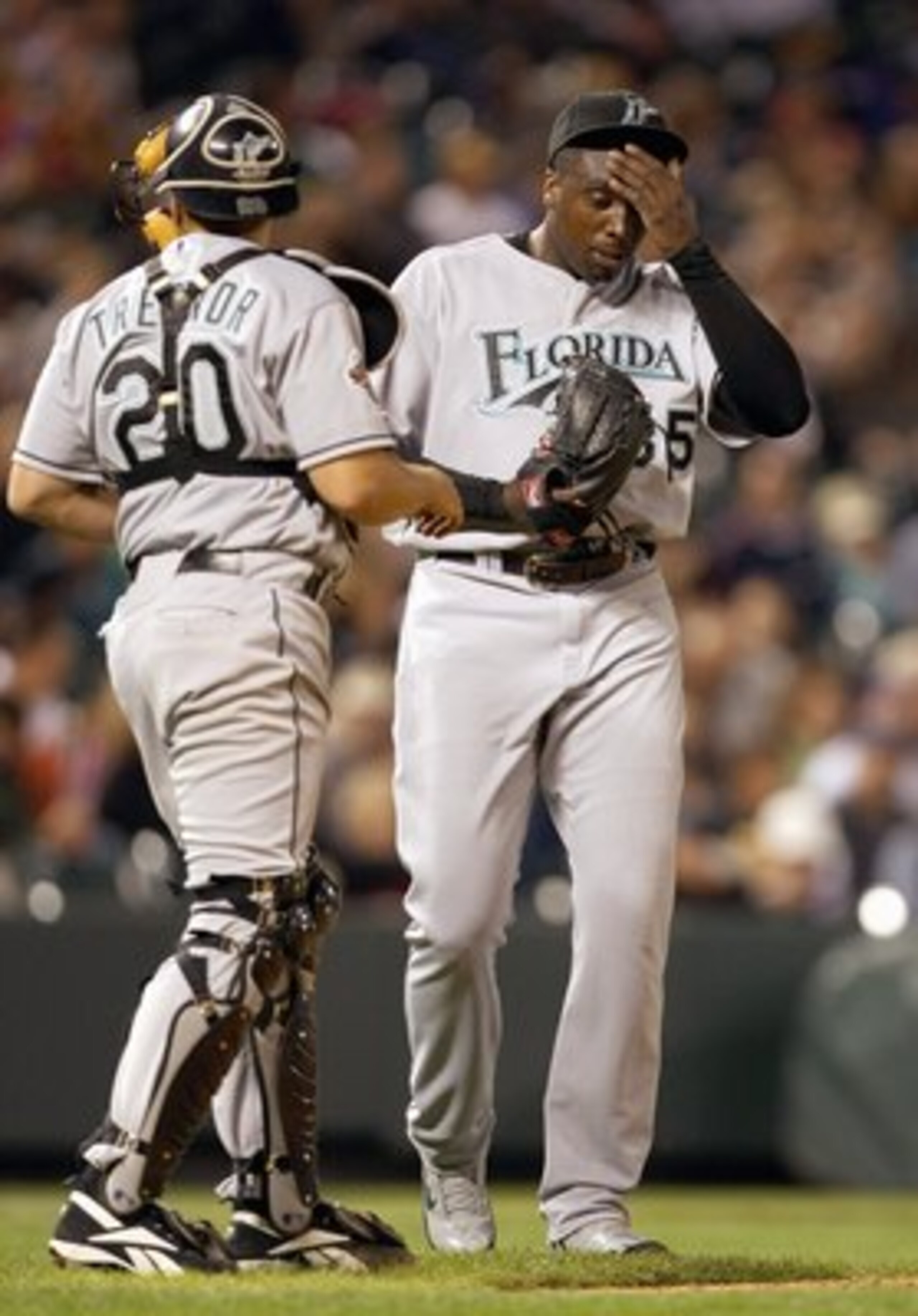 DENVER - SEPTEMBER 14: Starting pitcher Dontrelle Willis #35 of the Florida Marlins reacts with Miguel Olivo #30 against the Colorado Rockies at Coors Field on September 14, 2007 in Denver, Colorado. (Photo by Doug Pensinger/Getty Images) DENVER - SEPTEMBER 14: Starting pitcher Dontrelle Willis #35 of the Florida Marlins reacts with Miguel Olivo #30 against the Colorado Rockies at Coors Field on September 14, 2007 in Denver, Colorado. (Photo by Doug Pensinger/Getty Images)