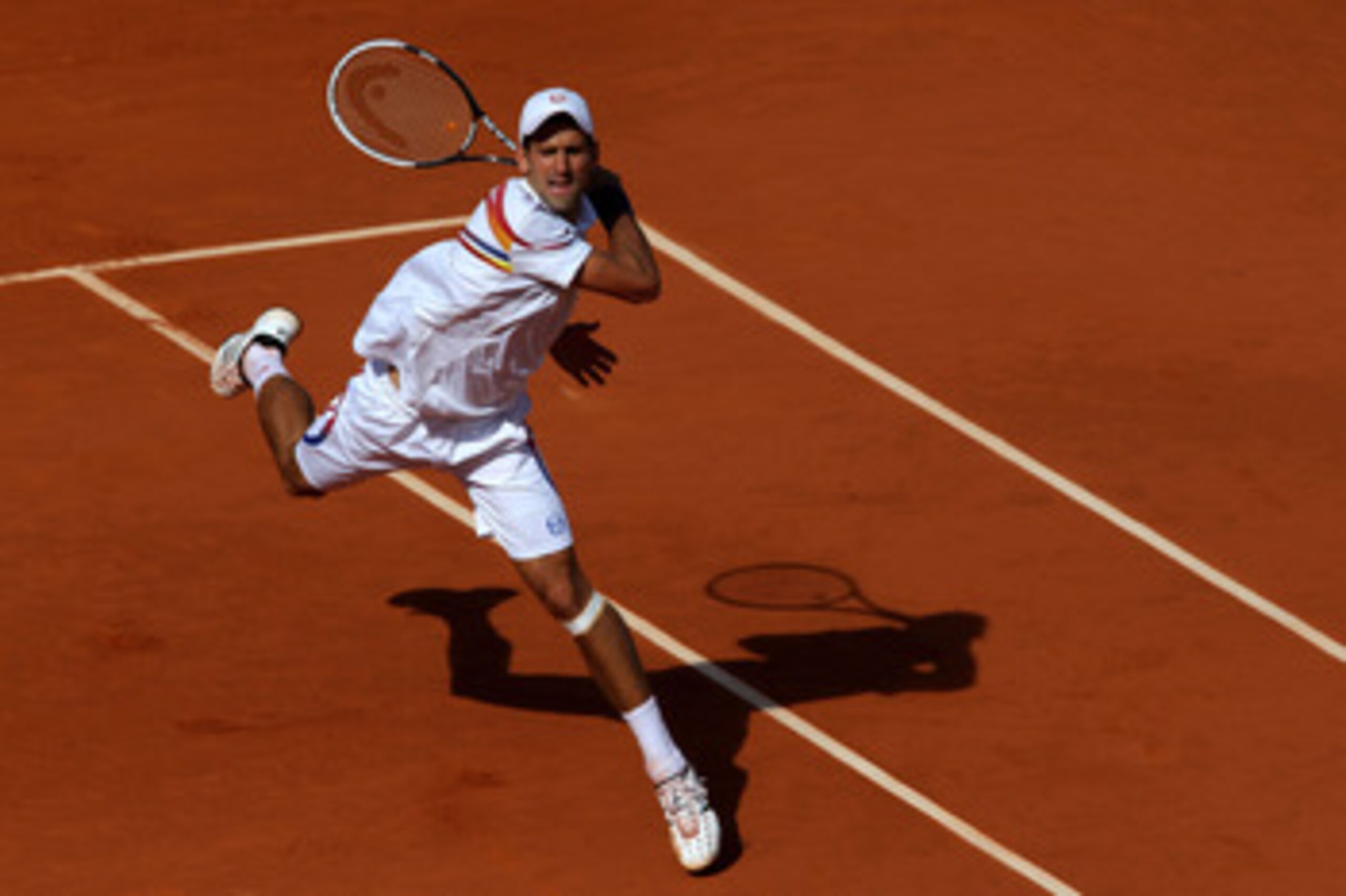 PARIS, FRANCE - MAY 29:  Novak Djokovic of Serbia hits a forehand during the men's singles round four match between Richard Gasquet of France and Novak Djokovic of Serbia on day eight of the French Open at Roland Garros on May 29, 2011 in Paris, France.  