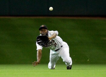 HOUSTON - MAY 24:  Centerfielder Michael Bourn #21 of the Houston Astros mkaes a diving catch on a line drive by Matt Kemp of the Los Angeles Dodgers at Minute Maid Park on May 24, 2011 in Houston, Texas.  (Photo by Bob Levey/Getty Images)