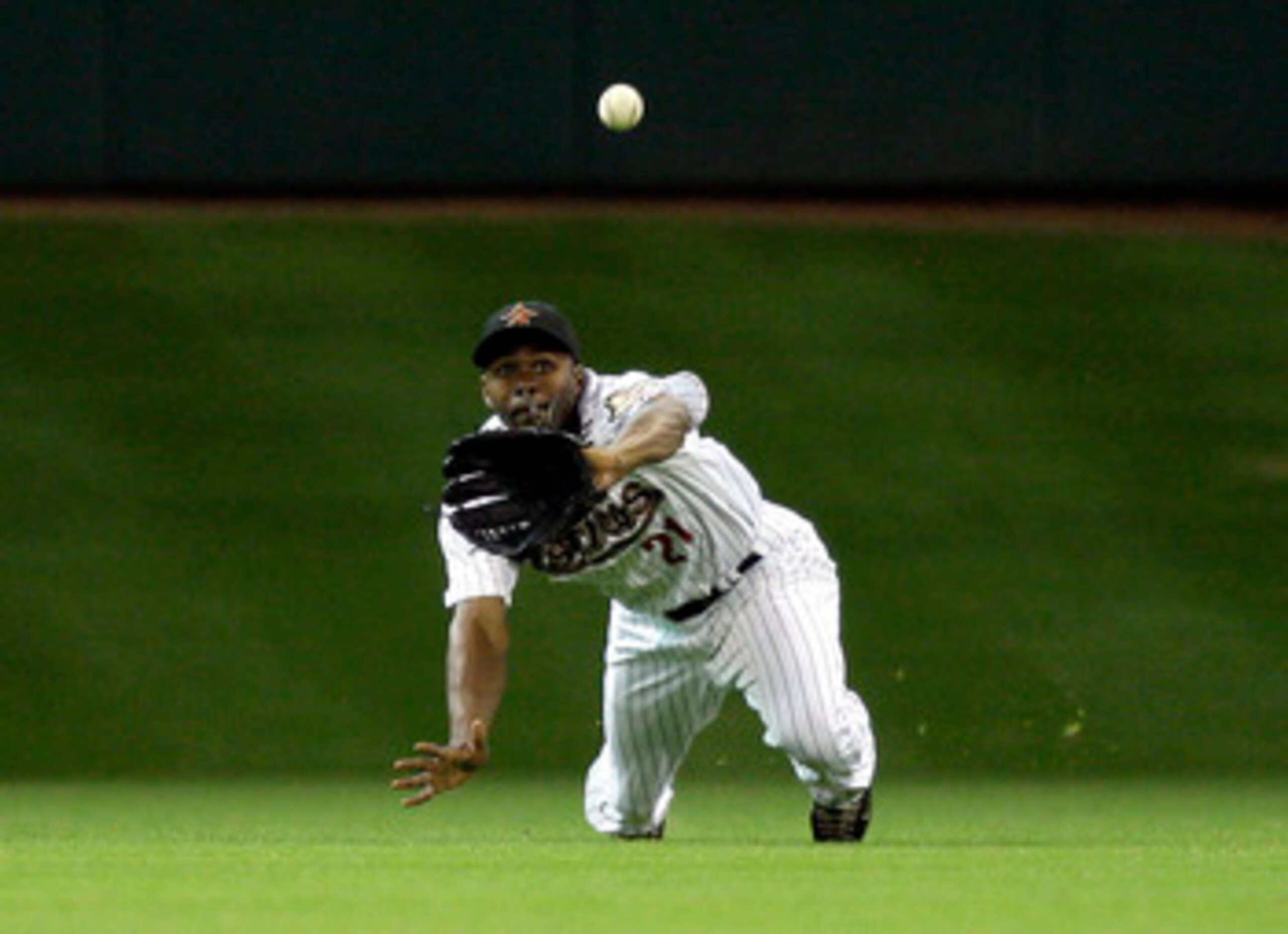 HOUSTON - MAY 24:  Centerfielder Michael Bourn #21 of the Houston Astros mkaes a diving catch on a line drive by Matt Kemp of the Los Angeles Dodgers at Minute Maid Park on May 24, 2011 in Houston, Texas.  (Photo by Bob Levey/Getty Images)