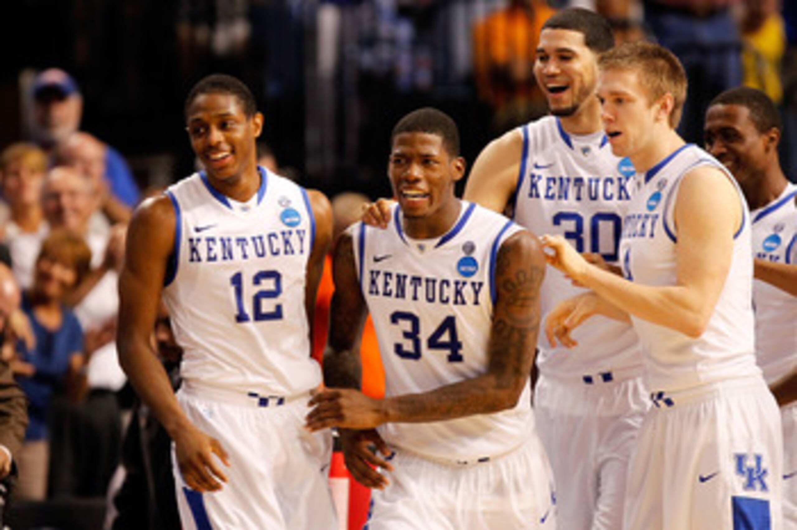 TAMPA, FL - MARCH 19:  (L-R) Brandon Knight #12, DeAndre Liggins #34, Eloy Vargas #30 and Jon Hood #4 of the Kentucky Wildcats celebrate after they won 71-63 against the West Virginia Mountaineers during the third round of the 2011 NCAA men's basketball t