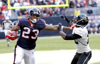 HOUSTON - JANUARY 02: Running back Arian Foster #23 of the Houston Texans gives Don Carey #22 of the Jacksonville Jaguars a stiff arm at Reliant Stadium on January 2, 2011 in Houston, Texas. (Photo by Bob Levey/Getty Images) HOUSTON - JANUARY 02: Running back Arian Foster #23 of the Houston Texans gives Don Carey #22 of the Jacksonville Jaguars a stiff arm at Reliant Stadium on January 2, 2011 in Houston, Texas. (Photo by Bob Levey/Getty Images)