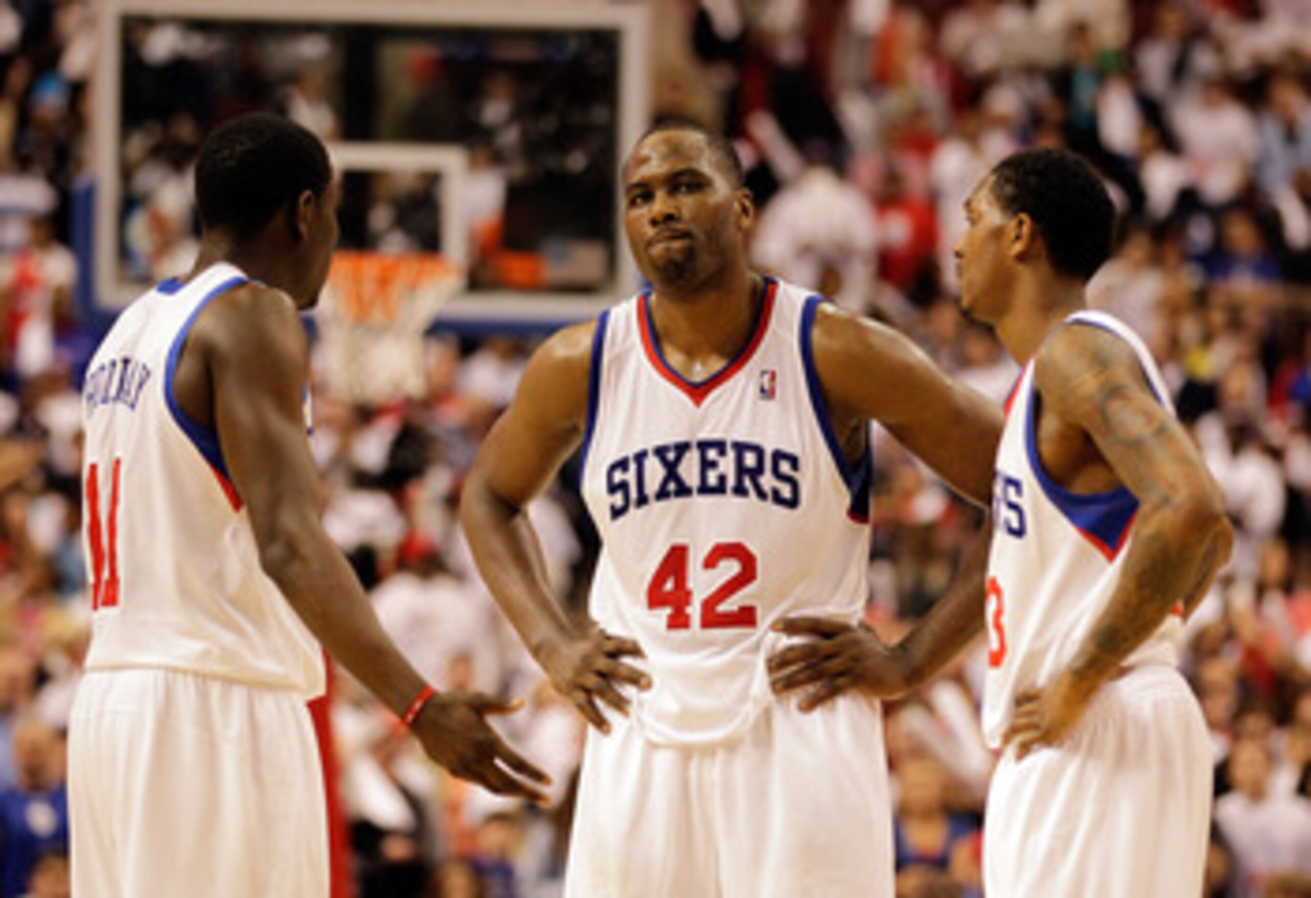 PHILADELPHIA, PA - APRIL 21: Elton Brand #42 of the Philadelphia 76ers talks with teammates Jrue Holiday #11 (L) and Lou Williams #23 (R)  during the closing moments of their game against the Miami Heat during game three of the Eastern Conference Quarterf