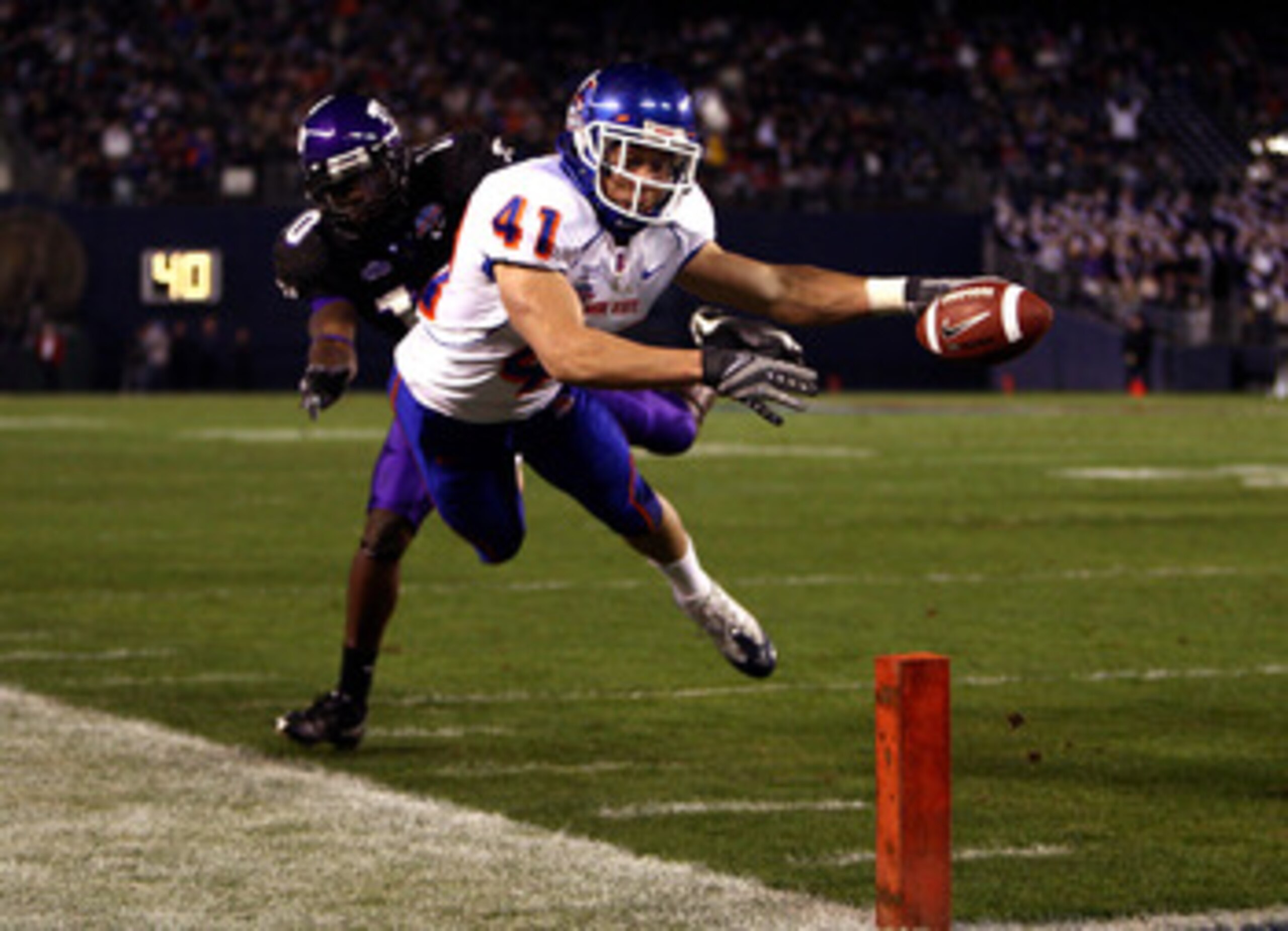 SAN DIEGO, CA - DECEMBER 23: Runningback Ian Johnson #41 of the Boise State Broncos dives for the endzone pilon against the defense of Cornerback Rafael Priest #10 of TCU during the San Diego County Credit Union Poinsettia Bowl at Qualcomm Stadium on Dec SAN DIEGO, CA - DECEMBER 23: Runningback Ian Johnson #41 of the Boise State Broncos dives for the endzone pilon against the defense of Cornerback Rafael Priest #10 of TCU during the San Diego County Credit Union Poinsettia Bowl at Qualcomm Stadium on Dec