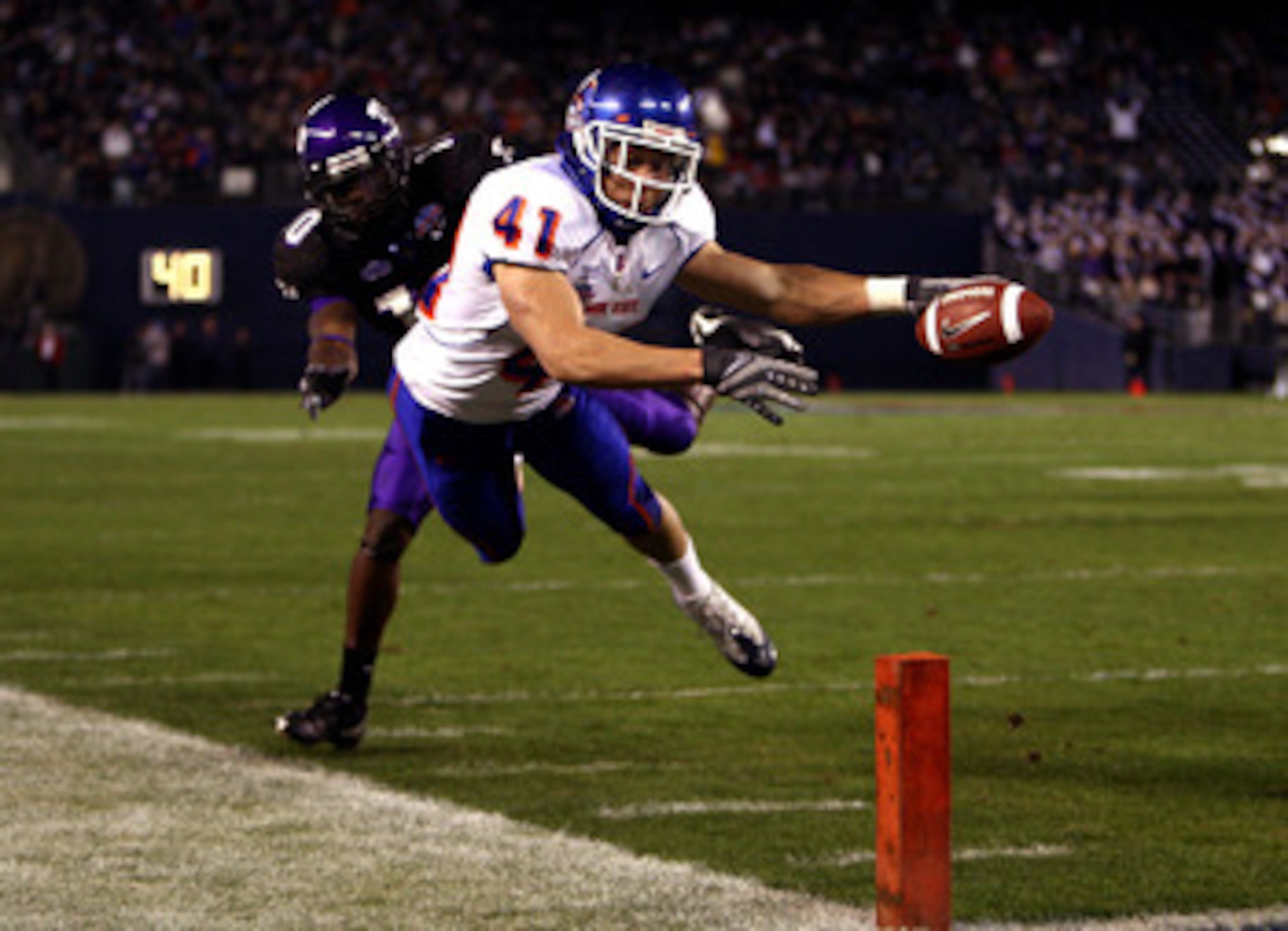 SAN DIEGO, CA - DECEMBER 23: Runningback Ian Johnson #41 of the Boise State Broncos dives for the endzone pilon against the defense of Cornerback Rafael Priest #10 of TCU during the San Diego County Credit Union Poinsettia Bowl at Qualcomm Stadium on Dec SAN DIEGO, CA - DECEMBER 23: Runningback Ian Johnson #41 of the Boise State Broncos dives for the endzone pilon against the defense of Cornerback Rafael Priest #10 of TCU during the San Diego County Credit Union Poinsettia Bowl at Qualcomm Stadium on Dec