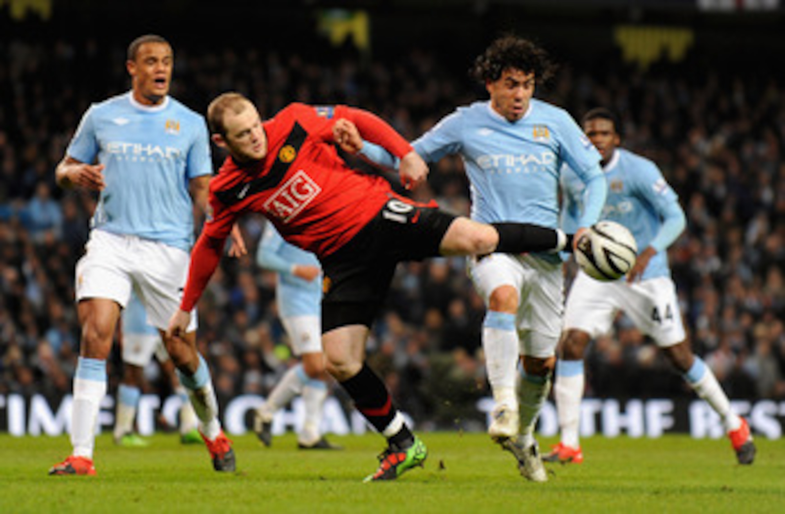 MANCHESTER, UNITED KINGDOM - JANUARY 19: Wayne Rooney of Manchester United battles for the ball with Carlos Tevez of Manchester City during the Carling Cup Semi Final match between Manchester City and Manchester United at the City of Manchester Stadium MANCHESTER, UNITED KINGDOM - JANUARY 19: Wayne Rooney of Manchester United battles for the ball with Carlos Tevez of Manchester City during the Carling Cup Semi Final match between Manchester City and Manchester United at the City of Manchester Stadium