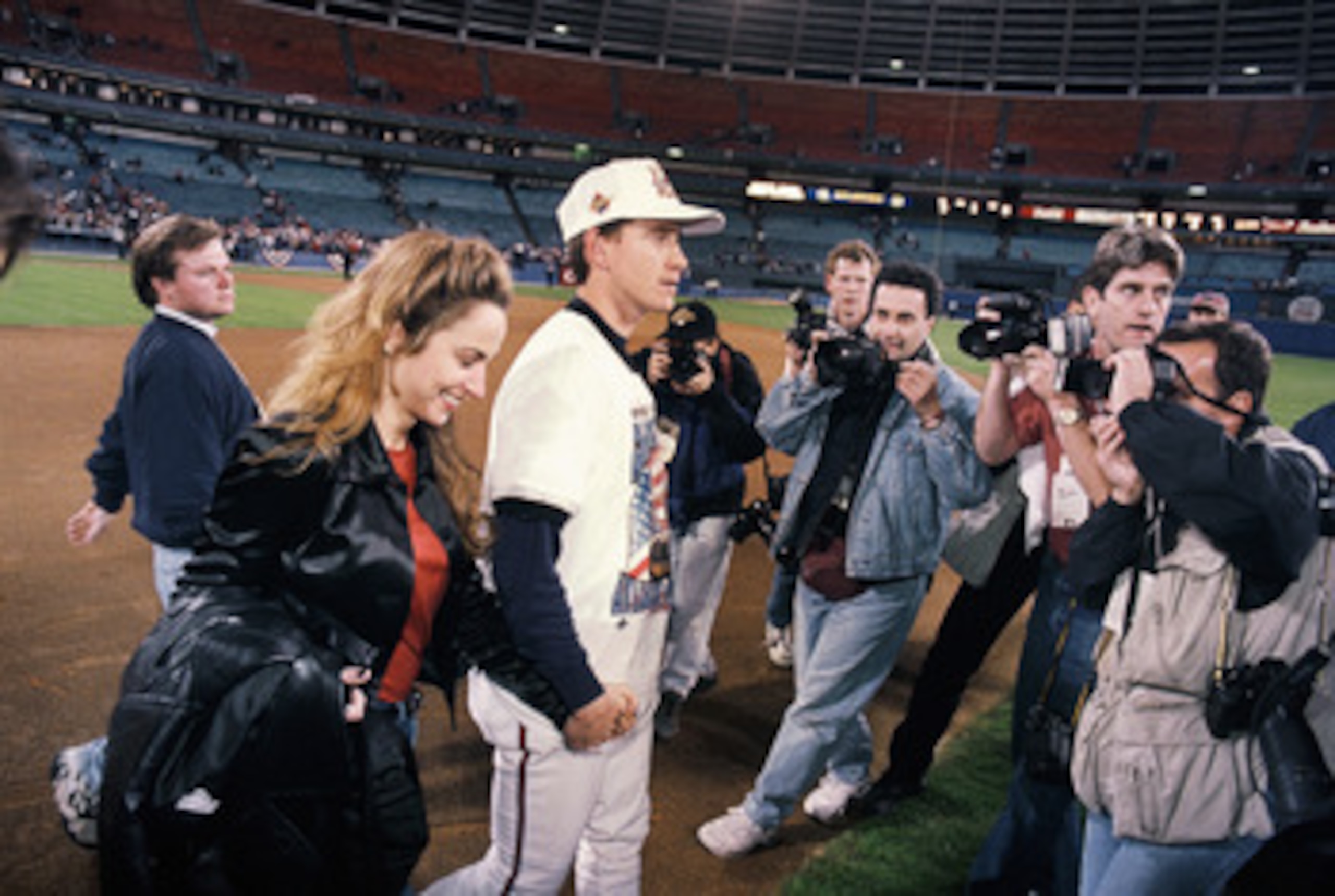 ATLANTA - OCTOBER 28:  Tom Glavine #47 of the Atlanta Braves walks off the field surrounded by photographers following Game six of the 1995 World Series against the Cleveland Indians at Atlanta-Fulton County Stadium on October 28, 1995 in Atlanta, Georgia