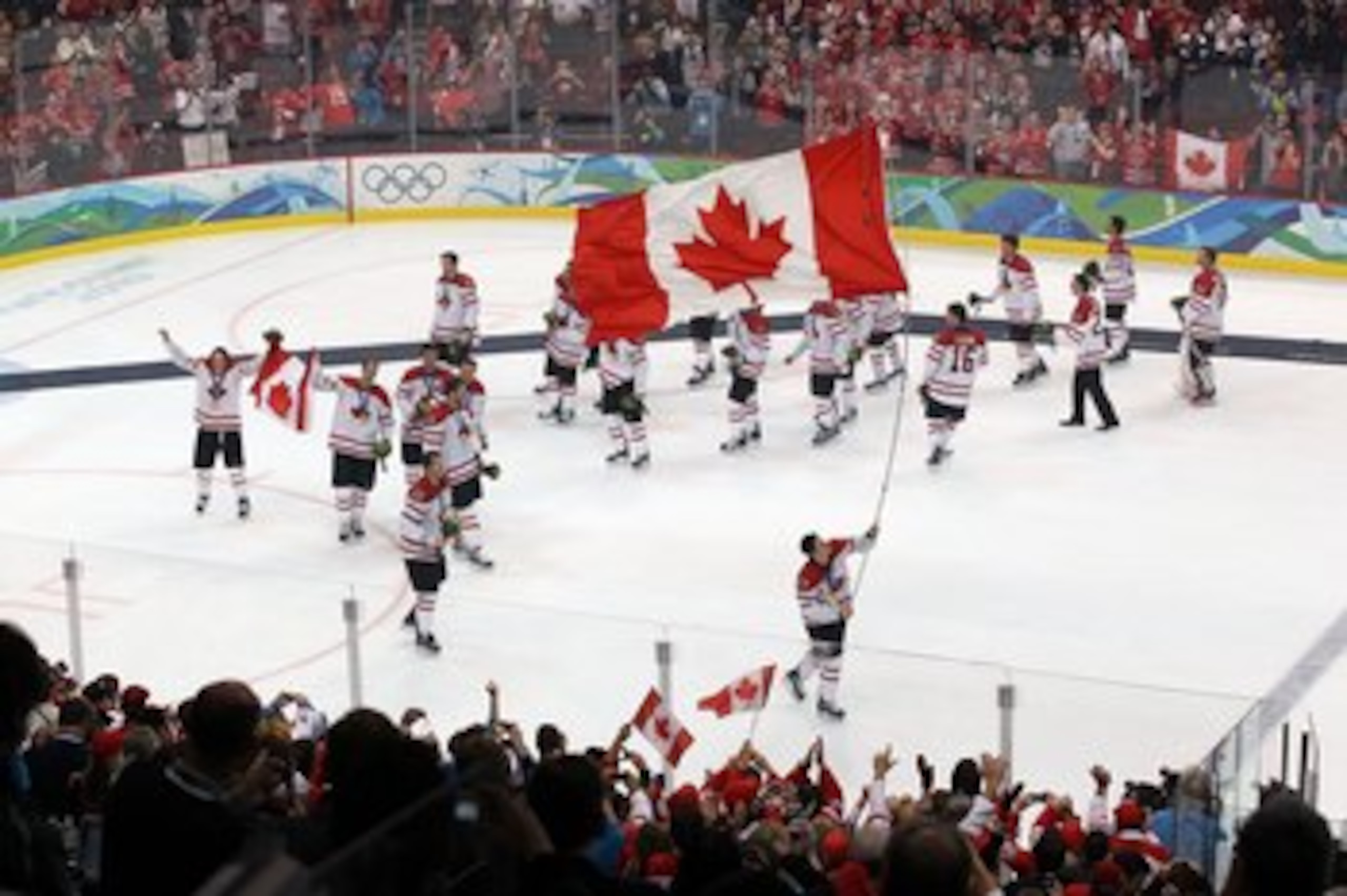 VANCOUVER, BC - FEBRUARY 28:  Sidney Crosby #87 of Canada skates with the Canadian national flag following Canada's 3-2 overtime victory during the ice hockey men's gold medal game between USA and Canada on day 17 of the Vancouver 2010 Winter Olympics at 