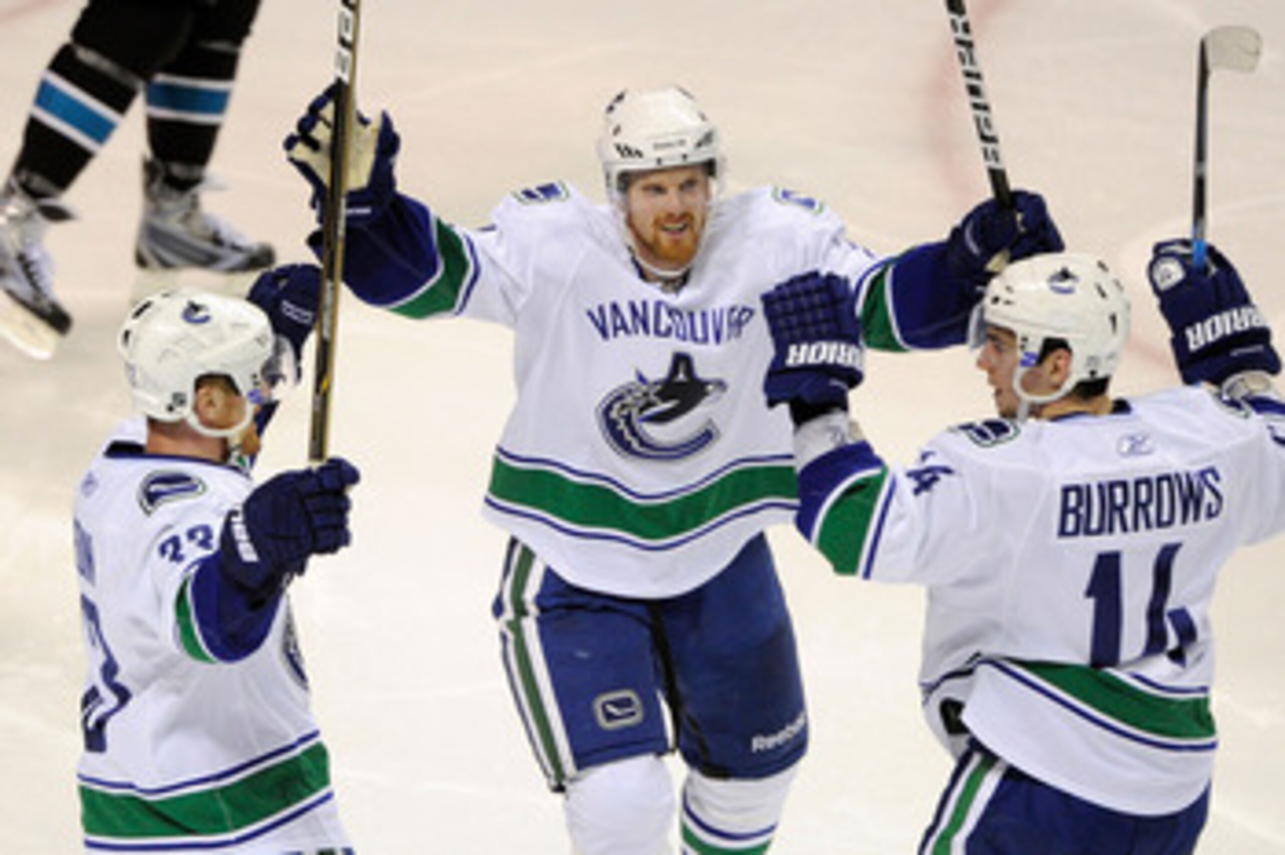 SAN JOSE, CA - MAY 20:  Henrik Sedin #33, Daniel Sedin #22 and Alex Burrows #14 of the Vancouver Canucks celebrate Burrow's third period goal in Game Three of the Western Conference Finals against the San Jose Sharks during the 2011 Stanley Cup Playoffs a