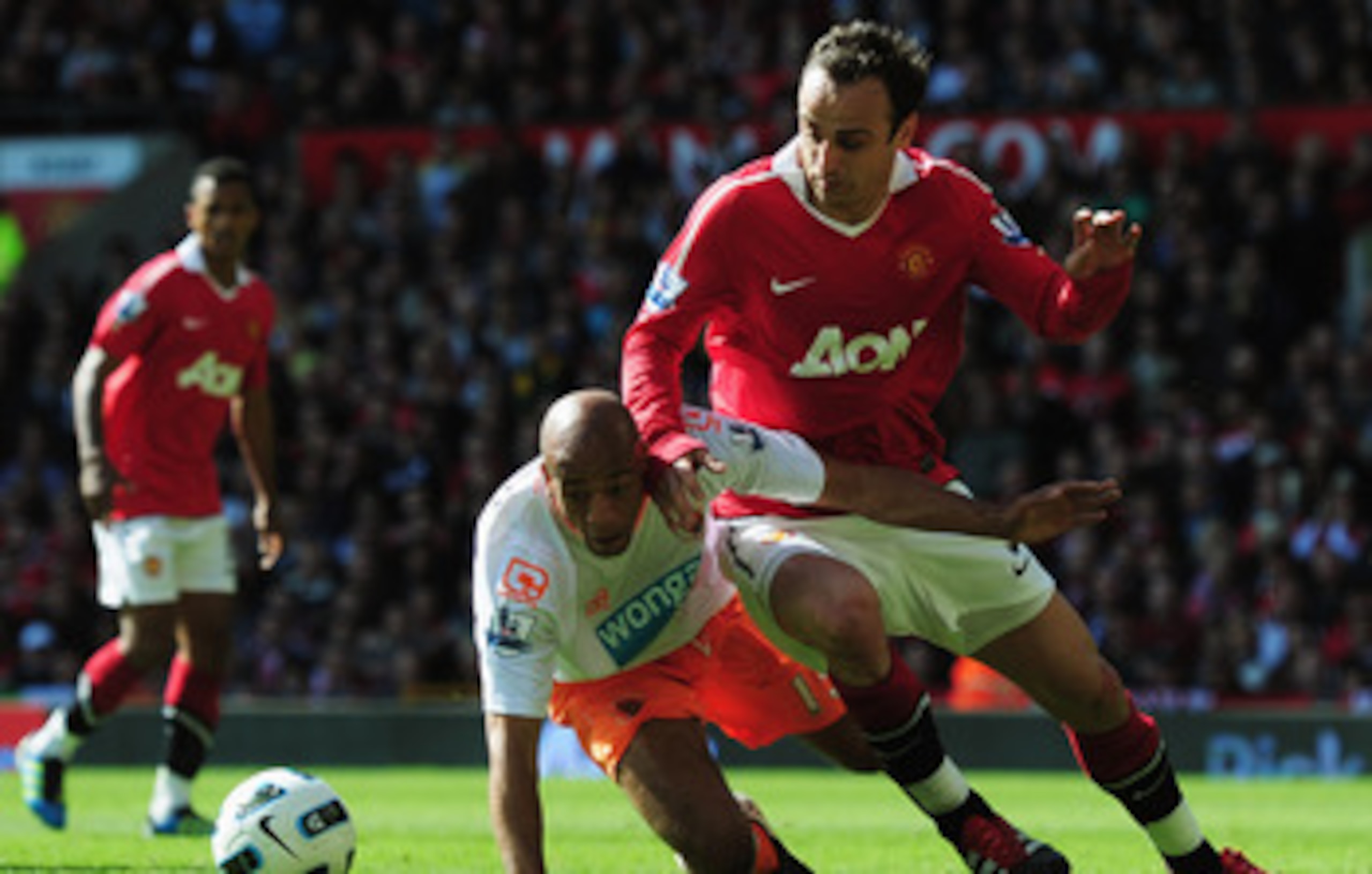 MANCHESTER, ENGLAND - MAY 22:  Dimitar Berbatov of Manchester United battles withAlex John-Baptiste of Blackpool during the Barclays Premier League match between Manchester United and Blackpool at Old Trafford on May 22, 2011 in Manchester, England.  (Pho
